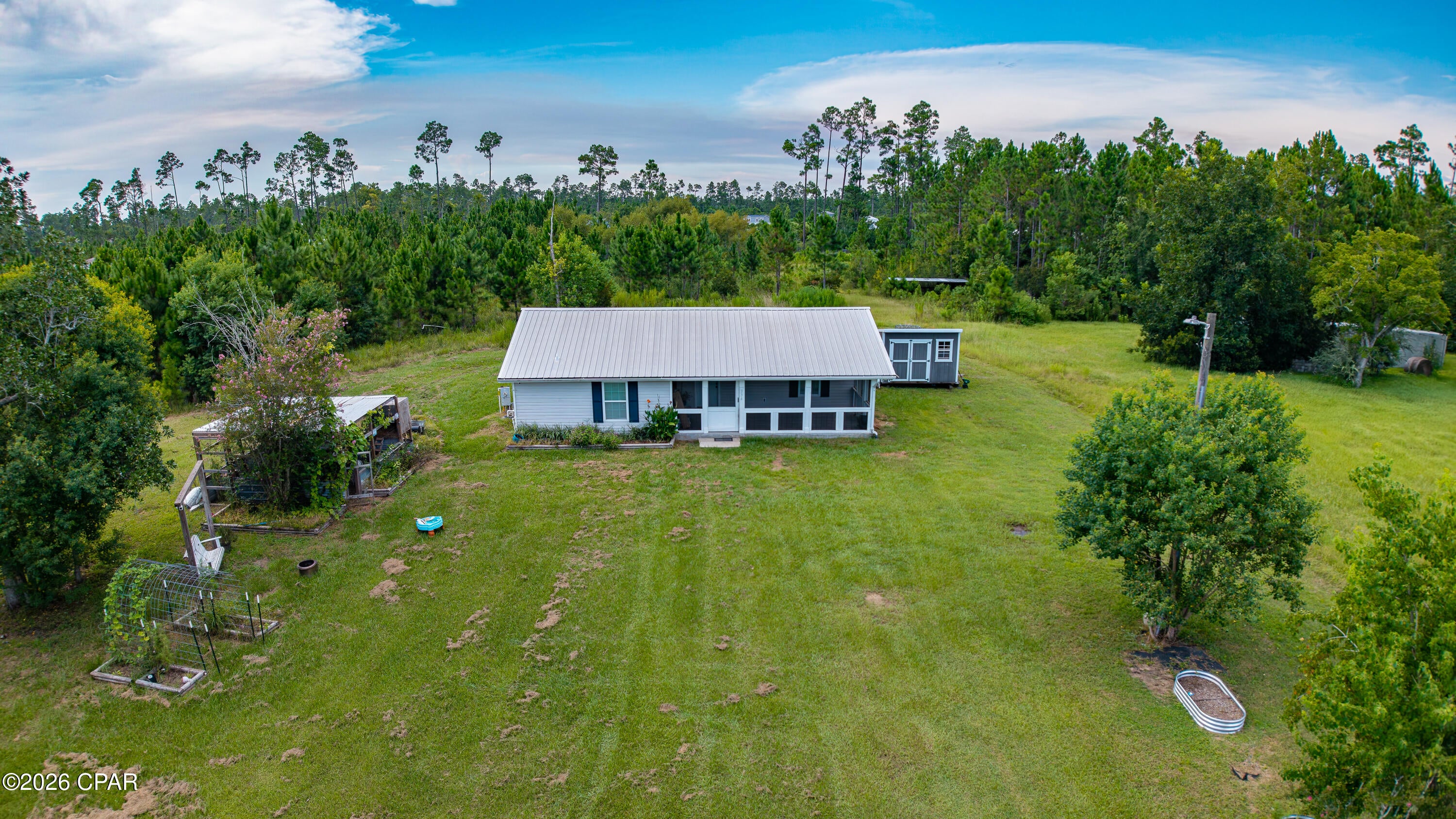 Homesteader's paradise! If you're looking for the perfect property to grow a garden, raise free range chickens, and watch the kids play in the yard, you've found it! Privacy. Peace. Convenience. All in one spot! (Conveniently located near Tyndall AFB, Lynn Haven, Panama City, Panama City Beach, and local waterways/boat ramps.) 
Situated on over 3/4 of an acre of quiet country living, accented perfectly by a massive screened porch; This is ''old Florida'' living! Water your vegetable and flower gardens from your well, enjoy your farm fresh eggs from your flock as they sit safe in their oversized coup, clean the ''catch of the day'' at your cleaning station, and enjoy the tranquility of country living while taking in the sunset from the front yard swing. (all whilst maintaining the convenience of being 20 minutes from all of the dining, shopping, and entertainment Lynn Haven, Panama City, and Panama City Beach have to offer!)
If the property itself isn't impressive enough, step inside to this thoughtfully designed 4 bed, 3 bath, recently remodeled ranch home! 
A massive open concept kitchen and living area greets you as you enter. Entertaining will be a breeze due the the thoughtful layout, granite countertops, updated appliances, and beautiful dark, low maintenance tile flooring! 
The central kitchen and living area are surrounded by oversized bedrooms with their own ensuite baths! The master bedroom alone is approximately 400 square feet and features a two person jacuzzi style tub in the master bath! Even the secondary bedrooms are massive and well appointed. 
If you're looking for a little more space and privacy for the family without sacrificing the convenience of being close to the city, you're going to want to check this one out! 
(Storage shed does not convey) 
All measurements are approximate and should be confirmed if deemed important.
