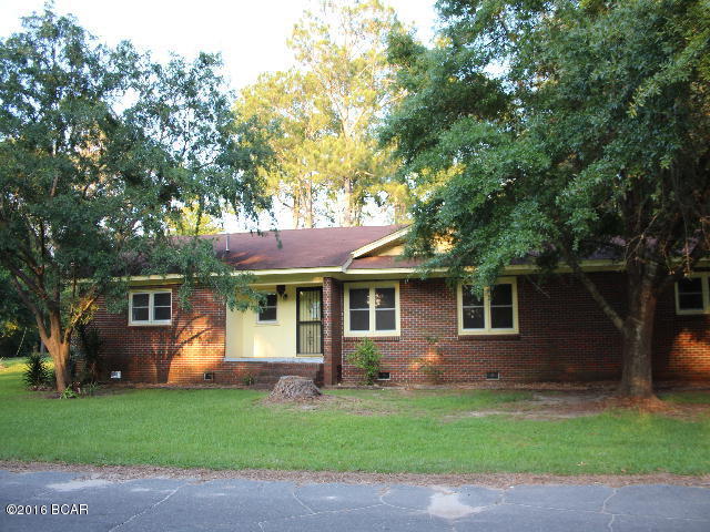 ** PRICE REDUCTION** Large home in town on nice corner shaded lot. This home has 4 bedrooms and 3 baths, a large country kitchen, a formal living room and an attached 2 car carport. There are two yard buildings with plenty of room for storage.