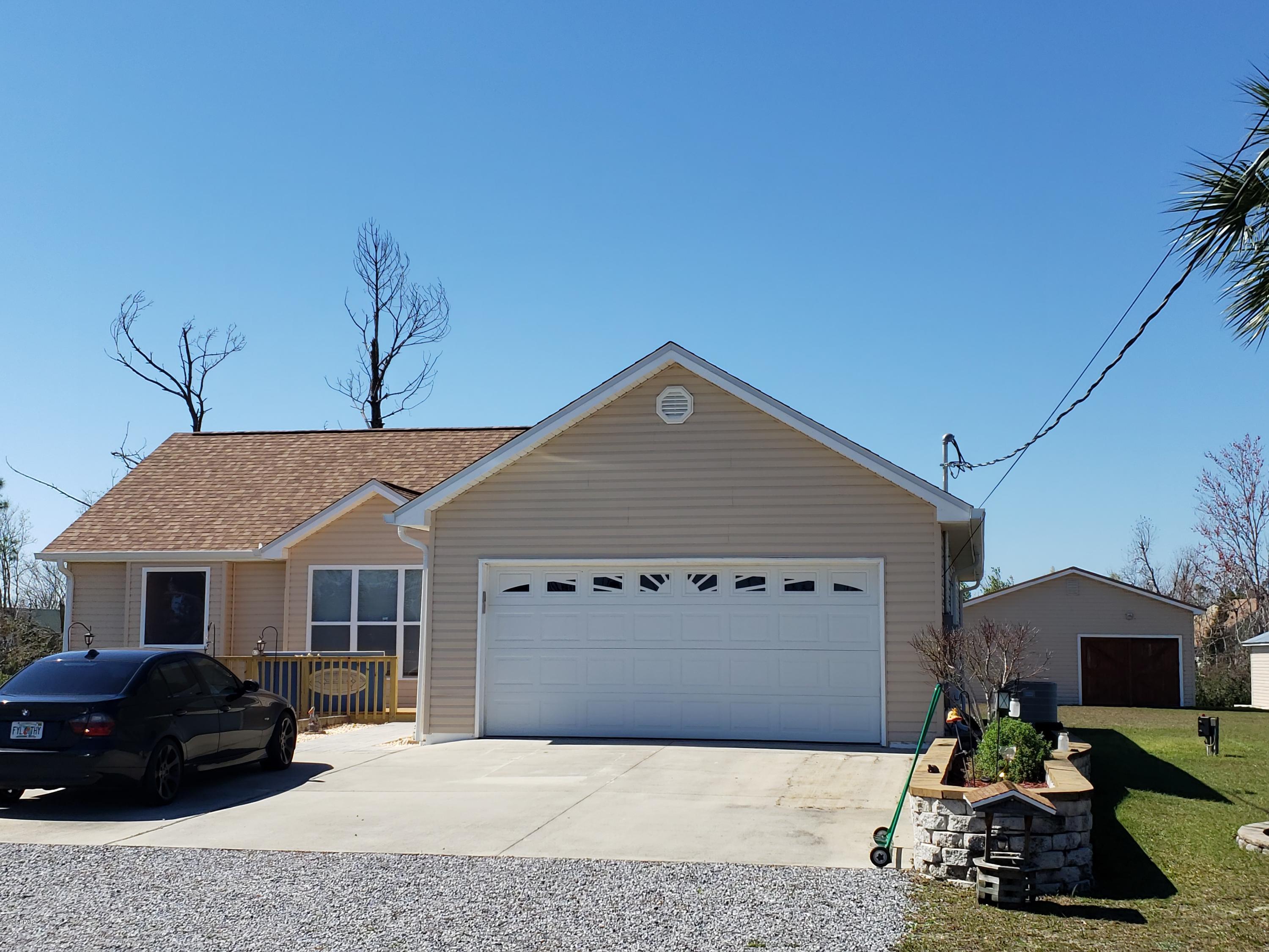 CURRENTLY UNDER CONTRACT, SELLER ACCEPTING BACK UP OFFERS.  This home is well cared for, ready to move into and is one a little over an acre.  Enjoy a spacious layout with large master bedroom and large bathroom with large jetted tub, galley kitchen with dining room and kitchen nook.  The back yard is complete with large wood deck and grill pit.  Offers a large 28x24 shop with electric and separate shed for yard equipment,  This home is located near shopping, restaurants and close to Tyndall AFB.