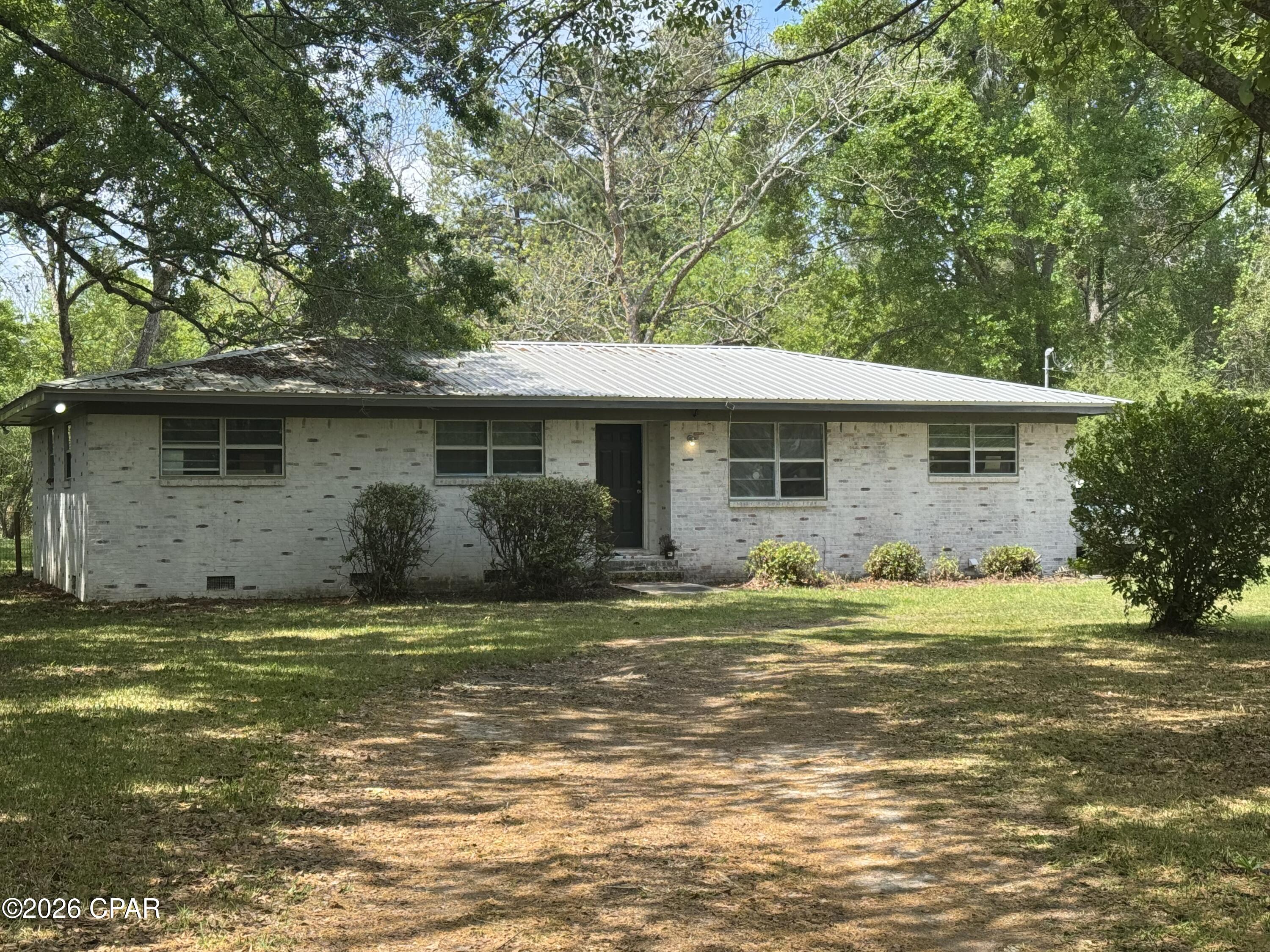 Looking for a cute brick home on a paved road close to town this could be the one. Large, fenced back yard, with a screened porch to rest and watch the sunset.  This home offers 3 bedrooms and a full bath. This home has had several upgrades in the past 6 years, new kitchen cabinets, a/c, roof, painted inside and out. Has a one car carport on the back that could easily be made into a den, office or add a master bedroom with a bath. Call for your appointment to view today .