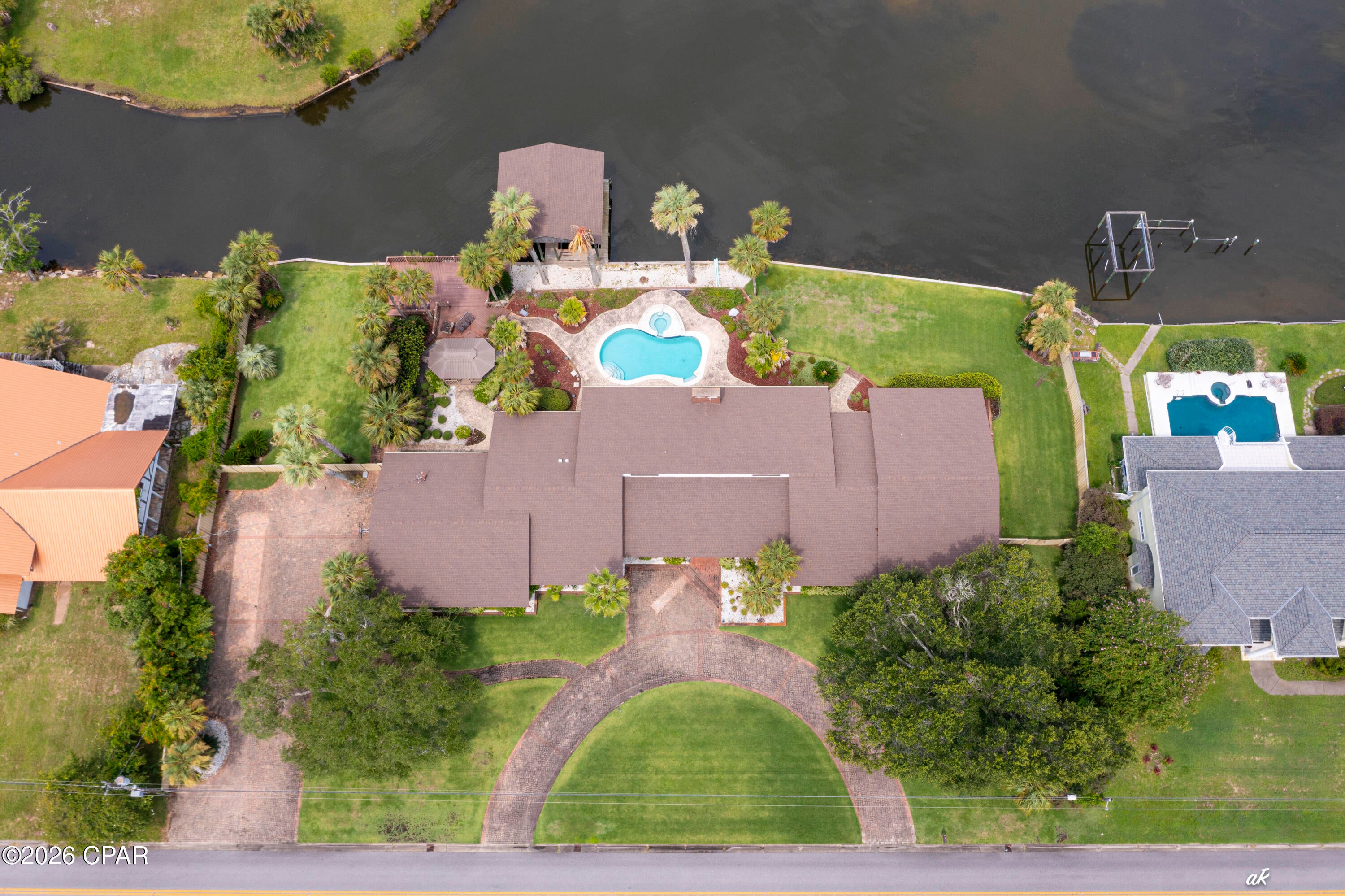 Sellers are Motivated! Luxury Waterfront Living on North Bay-Welcome to one of Lynn Haven's premier waterfront homes with 240' of waterfront! This 4,950 square-foot executive residence offers 3 bedrooms, 4 and one-half bathrooms and  breathtaking view and sunsets. Beautiful in ground pool with hot tub and a double covered boathouse with two boat lifts. The marble entryway  leads you into a large living area dominated with picture windows providing views into North Bay and beyond. The spacious office has built in bookshelf/cabinets lining both walls and parquet flooring. The fireplace is surrounded with marble and a custom made mantle with mahogany carved back drop.