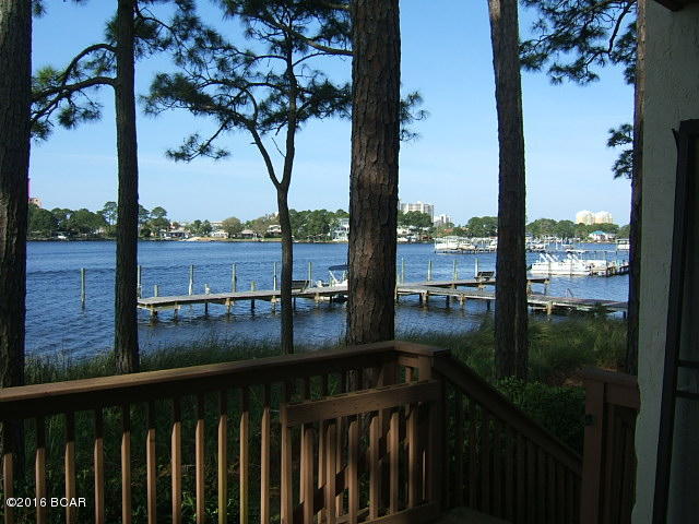 Condo located waterfront on Grand Lagoon. Downstairs living room & upstairs master bedroom have decks overlooking the water and boat docks. Boat docks supplied to homeowners first come first serve but most are empty. Community room with pool and tennis court. Large oaks scattered through out the property make this a dream location for second home or retire. Most owners are permanent owners, short term rentals discouraged.