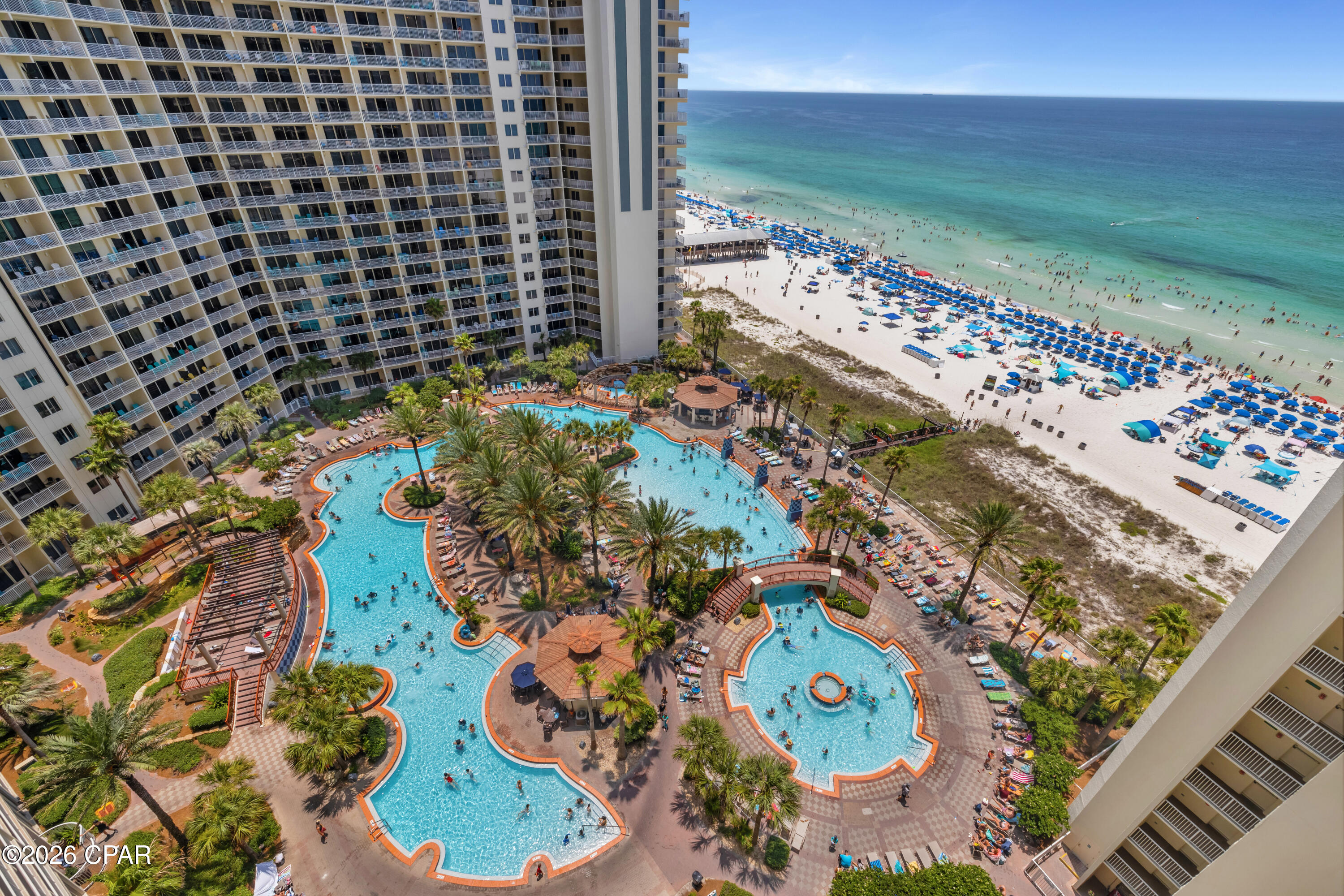 TROPICAL STYLE INSIDE. LAGOON POOL AND GULF VIEWS OUTSIDE. RIGHT BY THE ELEVATORS.

Shores of Panama 1408 is an A floor plan in Panama City Beach, offering a one-bedroom plus bunk layout, two full bathrooms, deeded parking, and a convenient 8-stack location just off the bank of elevators. This turnkey, fully furnished condo features coastal décor and furnishings, updated light fixtures, and luxury vinyl plank flooring throughout.

The living area is designed for easy use as a short-term rental or personal beach retreat, with open flow into the dining area and kitchen. The kitchen features granite countertops, white appliances, and a white subway tile backsplash. The primary bedroom includes a king-size bed and private bathroom with a tub/shower combo. Near the entry, the bunk area has access to its own full bathroom, giving the floor plan added functionality beyond a standard one-bedroom layout.

The balcony offers a strong resort-view setting with lagoon pool views and Gulf views from the 8th floor. Additional details include a deeded parking space on the 7th floor, water heater from 2016, and HVAC from 2006.

Shores of Panama Resort features one of the largest Gulf-front lagoon-style pools in Panama City Beach. The zero-entry tropical pool includes palm-lined islands, fountains, and a spacious hot tub along the resort's private beachfront access. Additional amenities include an indoor heated pool and hot tub, a 24-hour fitness center, and a seasonal poolside Tiki bar.

Located in the heart of Panama City Beach, Shores of Panama places dining, shopping, and entertainment nearby. Pineapple Willy's is adjacent to the resort, while Laketown Wharf directly across the street offers dining, retail, and entertainment options including Wharf Seafood Buffet, The Candymaker Ice Cream Shop, PCB Pizza, In Cahoots, The Press, The Bun Lab, 810 Billiards & Bowling, salon services, and more. Panama City Beach has also welcomed newer attractions and entertainment venues including Dolly Parton's Pirates Voyage Dinner & Show, Topgolf, McGuire's Irish Pub, and Tootsie's Orchid Lounge.

The same owner is also listing Shores of Panama 1410 (MLS 792217), positioned nearby on the same floor. For guests traveling together, the close front-door proximity creates a convenient two-unit setup with the same elevator access, separate private spaces, and more time together without being spread across the resort.

HOA dues are $3,326.18 per quarter. One special assessment payment remains in the amount of $1,155.20 (4th quarter of 2026)

Approximate Gross rental income was $23,000 in 2024, $28,000 in 2025, and $28,750 year-to-date through the end of June 2026. 

All information, rental income, HOA fees, assessments, measurements, and property details are deemed reliable but not guaranteed; buyer to verify if important.