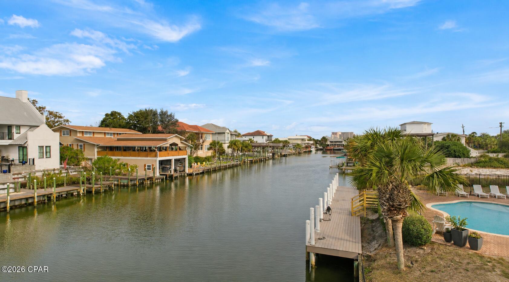 OPEN HOUSE! SATURDAY AUG. 29th from 2PM to 4:30PM, SUNDAY, AUG. 30TH from 10-12:30pm. Welcome to Holiday Isle! This 5-bedroom, 3-bath waterfront home comfortably sleeps 14 guests and offers an incredible opportunity as a primary residence, second home, or established vacation rental. The spacious open-concept living area is designed for entertaining and opens to one of the largest waterfront decks on Holiday Isle, providing plenty of room for outdoor dining, gatherings, and enjoying the water views. The deck has even been used to host weddings, offering endless possibilities for entertaining. Boating enthusiasts will appreciate the private dock with two boat lifts and a dedicated fish cleaning station. Cruise to Crab Island, spend the day fishing in the World's Luckiest Fishing Village, or explore Destin's waterways right from your backyard. The home also features a large second-floor front balcony, perfect for morning coffee or relaxing in the evening after a day on the water. Located just across the street from the Gulf of America, you'll enjoy a short walk to the private gated beach access where you can spend the day on Destin's sugar-white sand and emerald waters. With spacious accommodations, exceptional outdoor living, premier boating amenities, and an unbeatable Holiday Isle location, this property offers outstanding rental potential and the coastal lifestyle buyers are looking for.