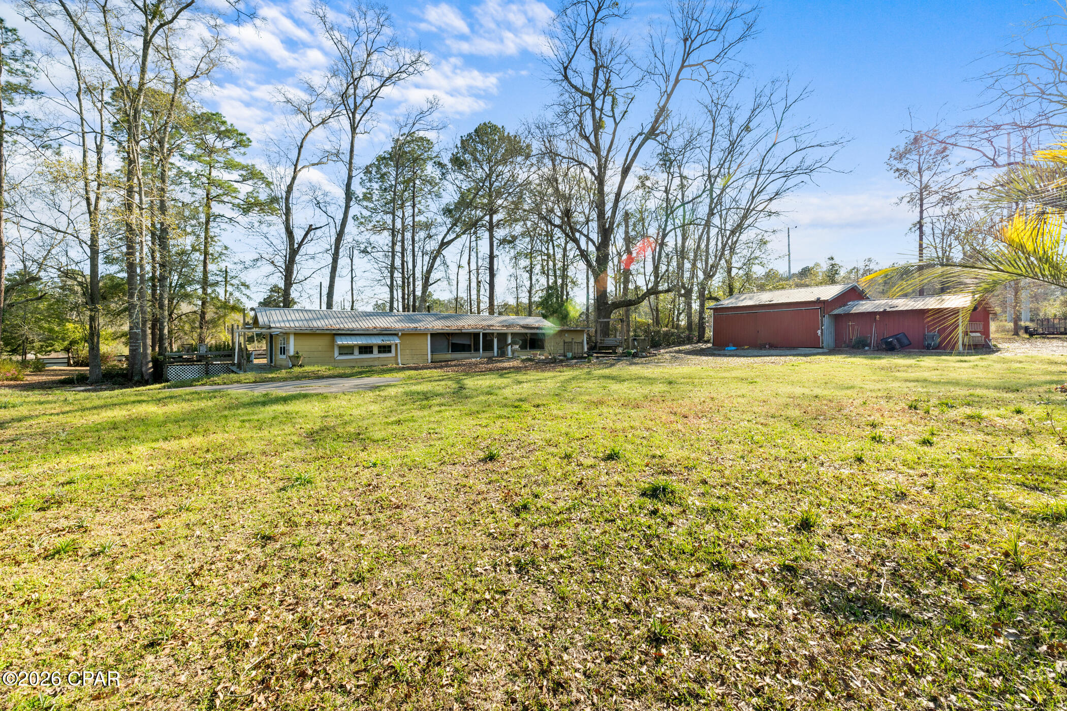 Investor Alert! Don't miss this opportunity to own 1.61 acres with prime Highway 2 frontage in Graceville. This property offers excellent visibility and accessibility, making it ideal for investors, rental income, or future development potential.

The property features a mobile home currently on site along with one pole barn and an additional small barn, providing great space for storage, equipment, or workshop use. With a generous lot size and unique layout, there's plenty of room to expand, improve, or reimagine the space to fit your vision.

Whether you're looking for a fix-and-hold investment, rental property, or land with high-traffic exposure, this one checks the boxes. No HOA and plenty of possibilities!