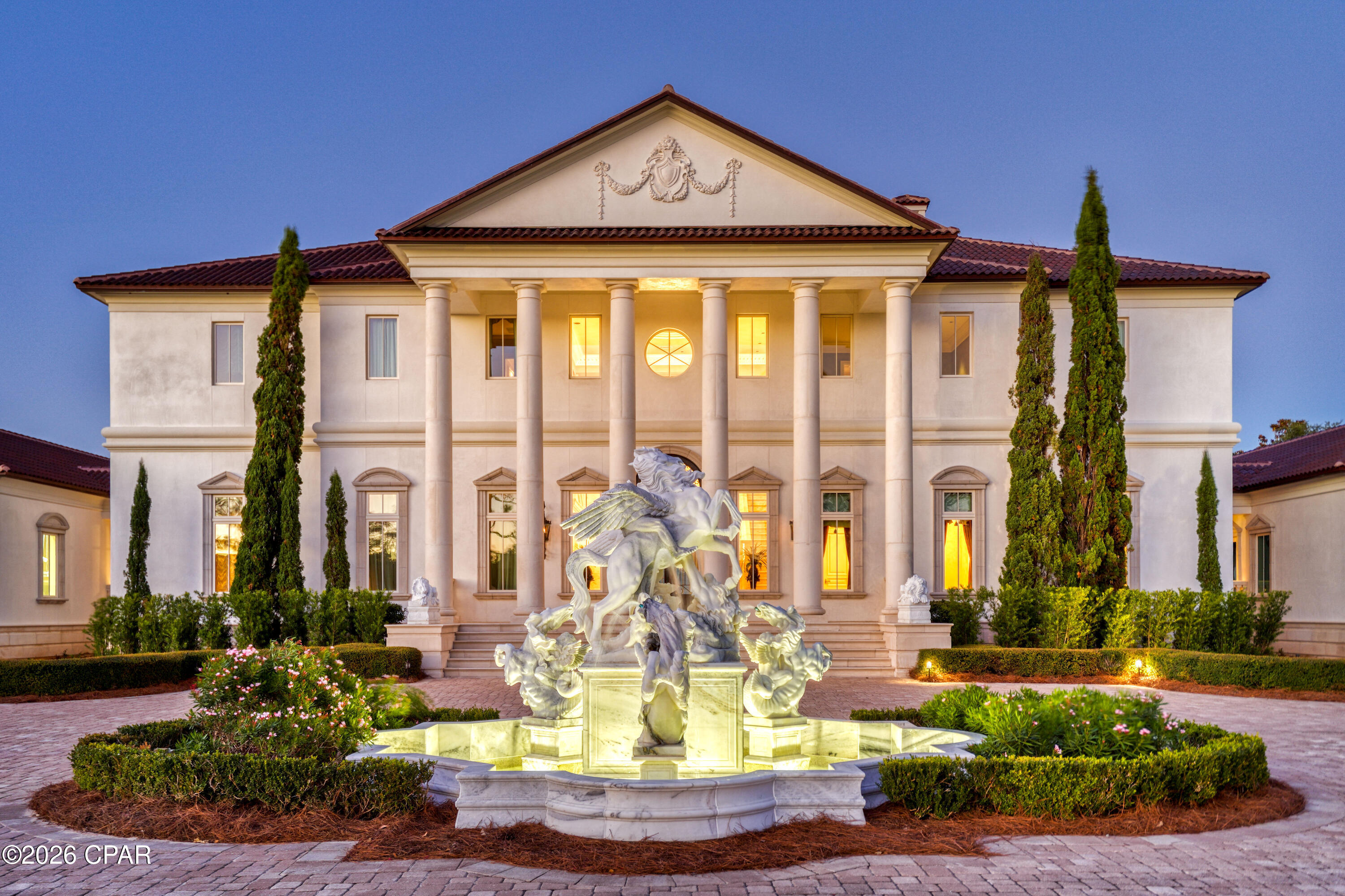 Perched on 380 feet of pristine West Bay waterfront along the Northwest Florida Gulf Coast, Villa Chimera is the most extraordinary luxury estate in Panama City Beach. Spanning 9,473 sq. ft. across three expansive lots, this 5BR/6BA/4HB masterpiece was authentically modeled after an Italian Venetian Palazzo -- designed by architect Philip Spann from hand-sketched owner drawings inspired by Renaissance master Andrea Palladio. Every finish was sourced from Italy or crafted by world-renowned artisans: a hand-carved Italian marble fountain, cushion-cut marble walls, Venetian silk upholstery, a Rome-crafted stone dining table, and a Renaissance fresco ceiling hand-painted by artist Jody Matokovich. This is not simply a Gulf Coast luxury home -- it is a one-of-a-kind legacy estate.

The soaring foyer commands immediate attention with its grand Schonbek crystal chandelier, custom compass rose marble floor inlay, and solid stone staircase with marble balusters. The great room overlooking West Bay features a marble fireplace, limestone accents, and walls upholstered in Bevilacqua silk -- made in Venice and renowned worldwide. A media room with a theater-size projection screen and theatrical lighting flows seamlessly from the living space.
The gourmet kitchen features Wolf and Sub-Zero appliances, a breakfast bar, separate bar area, and a fully equipped butler's pantry for effortless large-scale entertaining. All cabinetry was custom-designed by Design Galleria of Atlanta. The dining room centers around a custom stone table crafted in Rome outside the Vatican walls, beneath Venetian watermark plasterwork evoking centuries of Palazzo history.
The second-level master suite is a private sanctuary with bay views, a columned balcony, and a hand-painted Renaissance fresco vault ceiling. Separate his-and-hers bathrooms each feature heated floors and double showers with body jets. A detached guest house -- connected by covered walkway -- includes a full kitchen, sitting area, private veranda, and full bath.
Smart home living is delivered via a full Crestron system controlling all lighting, media, and security. Additional highlights: Kohler 100KW whole-house generator, all-copper plumbing, 4-car garage with wheelchair lift, whole-house central vacuum, monitored security cameras, LED lighting throughout, and all windows and exterior doors replaced post-Hurricane Michael. A rare and irreplaceable Florida Gulf Coast waterfront estate -- schedule your private showing today.