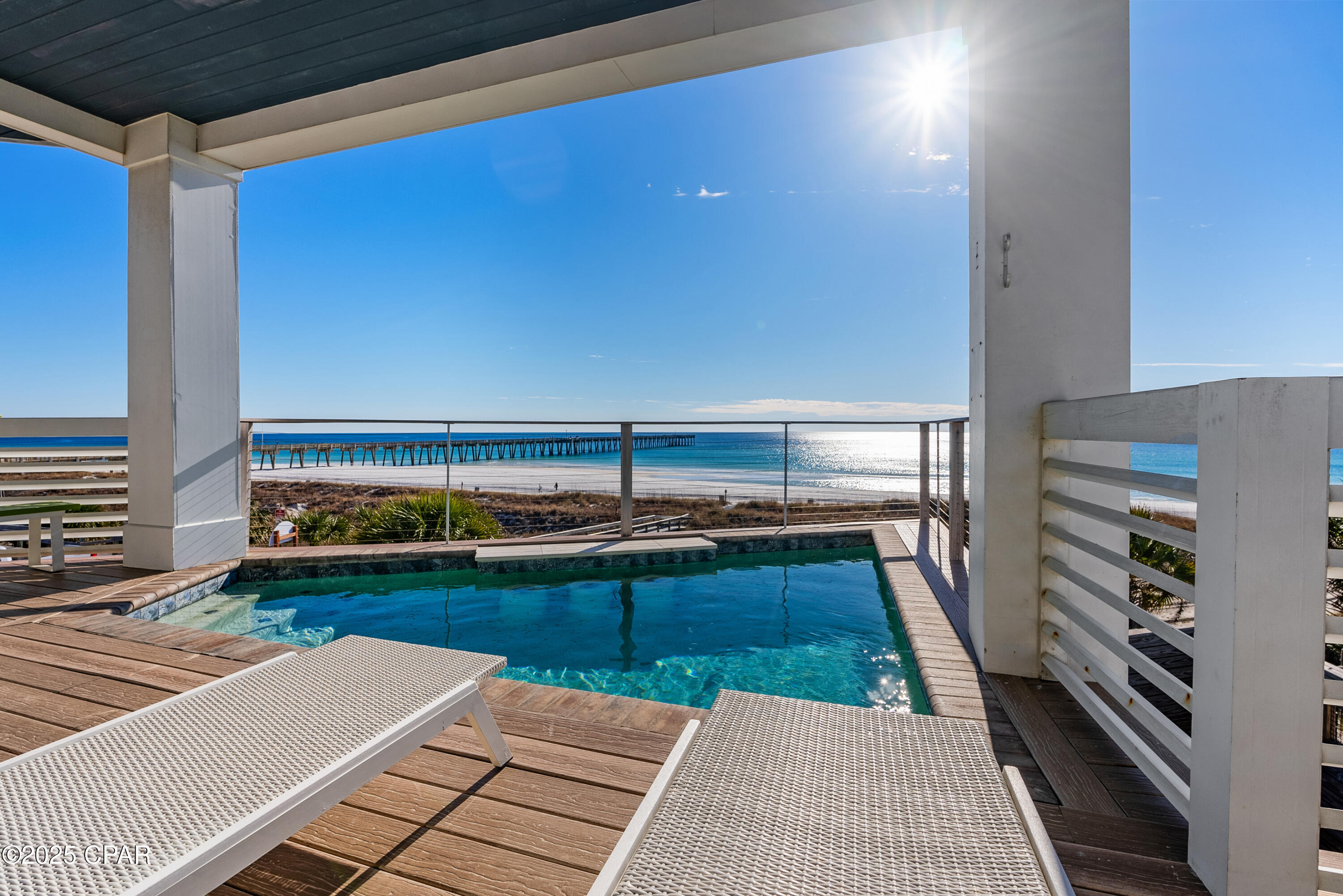 MASSIVE PRICE REDUCTION, HIGHLY MOTIVATED SELLER!! Find coastal luxury with this magnificent 6 bedroom/6 bathroom 2 half bath beachfront retreat, designed to accommodate up to 16 guests in unparalleled comfort. Nestled against the shoreline, this haven offers an array of exceptional amenities that promise an unforgettable escape. Immerse yourself in the allure of outdoor leisure with a dedicated lawn game area featuring foot pool, cornhole, and mini golf. A symphony of style awaits within, where each corner is adorned with tasteful décor. A fully equipped kitchen and a convenient kitchenette cater to your culinary desires, ensuring every meal is a delight. There is an indoor elevator equipped in this home to help quickly and conveniently navigate between floors. This beachfront gem also showcases private walkout balconies with soothing Gulf views on every floor, accessible from each bedroom.