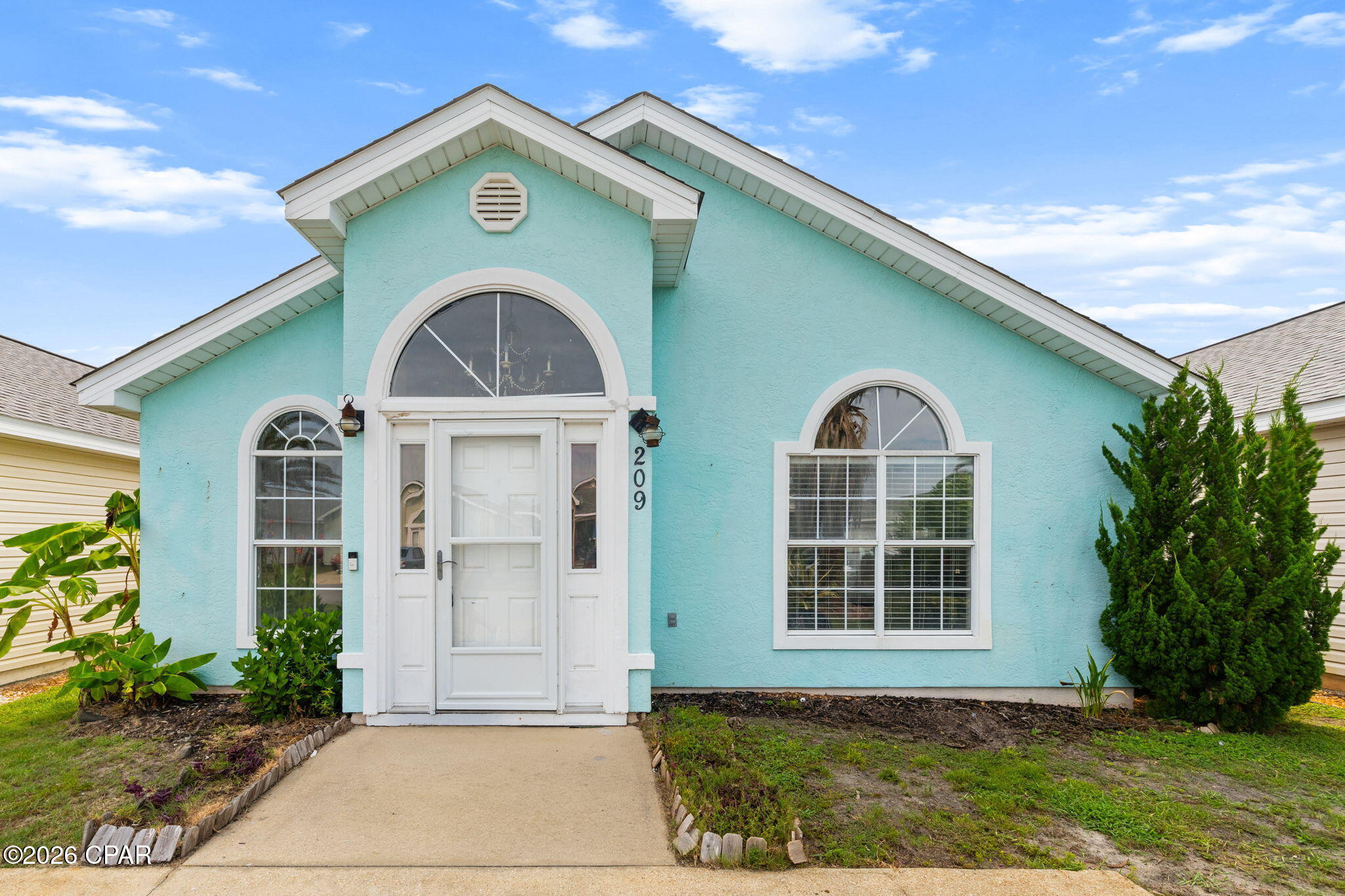 Welcome to coastal living in Panama City Beach! This 3-bedroom, 2-bath home features an open layout with a spacious eat-in kitchen flowing into the living room, where vaulted ceilings and abundant natural light create a bright, inviting space. A private hallway leads to the primary suite with an en-suite bath and ample closet space. Two additional bedrooms share a full hall bath just across the hall. Relax on the screened back porch and enjoy the Gulf breeze. HOA amenities include a community pool and playground. Just blocks from the beach, shopping, and dining, this home is ideal as a primary residence,  getaway, or short- or long-term rental investment.