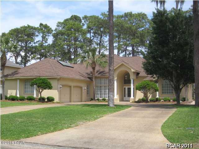 his beautiful home sits on the first fairway of the Panama Country Club. Newer roof, heating and a/c, 80 gallon solar heated water heater, remodeled full bath and everything in immaculate condition will provide you with peace of mind for years to come. It features a beautiful in-ground pool surrounded by brick pavers and completely screened in for those bug-free evenings relaxing in the water. Also included on the patio is a large hot tub for soothing those tired bones. Real hardwood floors, crown molding, 10 foot ceilings, central vacuum system and tasteful window treatments all combine to make this the first house you should show your buyers. All dimensions, measurements and other listing information should be verified if deemed important.