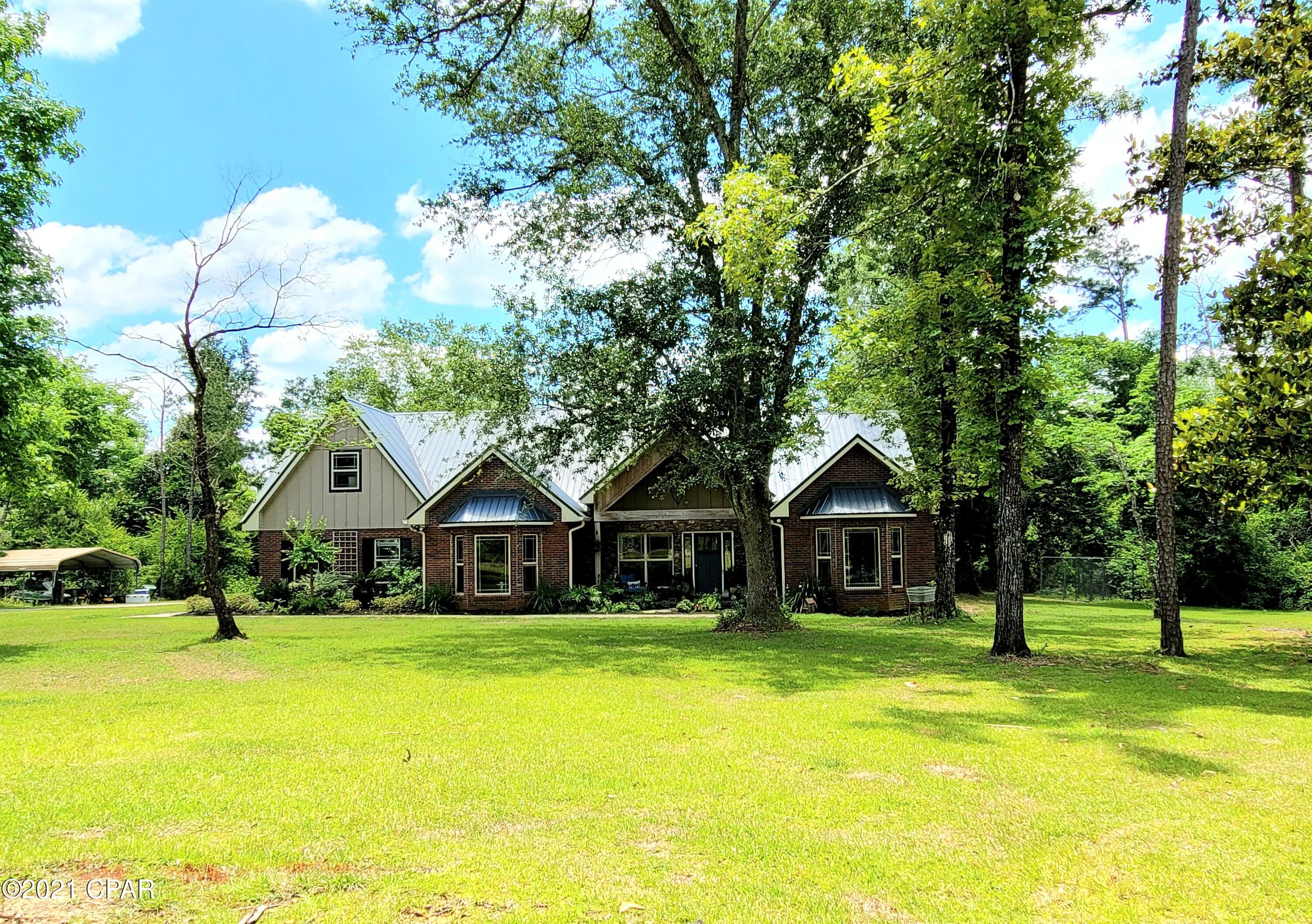 This 4/3 on the outskirts of Marianna is one of the most aesthetically pleasing homes to hit the market in a long time!!! From curb appeal, to woodwork, to layout, this one has it all. The first floor features an open floorplan, three bedrooms, two full baths, and an office/studio. If your master bedroom will be your fortress, you're looking at the right home. Trey ceilings with wood trim hover over matching hardwood floors and window trim. Master bathroom features a large custom tile shower and a double vanity. The kitchen has the most beautiful cabinetry, granite counter tops, a farm house style sink, and a large pantry. ''WOW'' factor is undeniable when you walk into the front door being met by beautiful hardwood flooring, a stone fireplace, and vaulted wood ceilings. Upstairs you will find another gorgeous bedroom and full bath attached to the small loft style living area. Above the two car garage is another bonus room!!! There aren't enough words to describe this one, you need to see it in person!