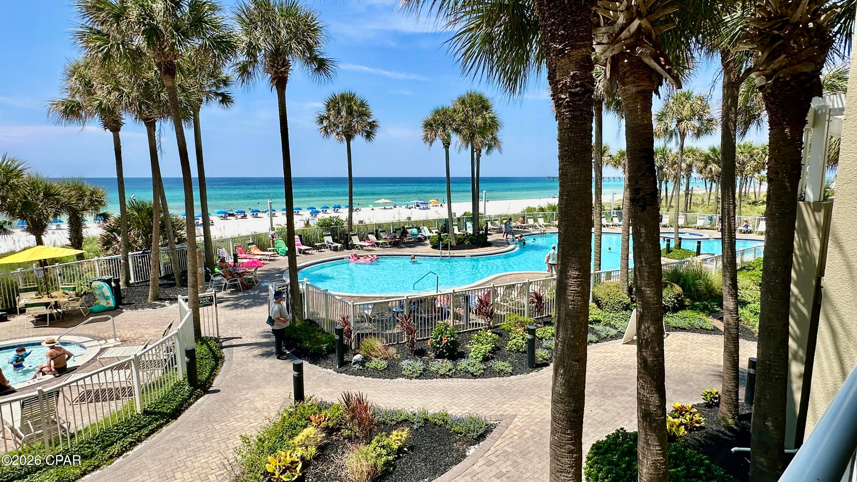 Welcome to the Spectacular Beach-Front Tower 1 of Grand Panama Resort, Unit 1-207 -- Your Gulf-Front Getaway on the Emerald Coast!  Experience breathtaking gulf views and effortless coastal living from the low 2nd floor of Grand Panama Resort. This fully furnished, rental-ready condominium offers the perfect combination of spaciousness, comfort, and resort-style amenities, making it an exceptional vacation home, investment property, or both. 

The standout features of this residence is its coveted spacious balcony, gulf-front master bedroom with balcony access, and low floor location, situated just one floor above street level (elevator waits not required with quick access to the beach/pool).  From the moment you enter the living area you'll sense the grandeur of the gulf with lush tropical pool, palm trees, and thoughtfully curated professional landscaping. Step outside onto the expansive private balcony where there's plenty of room to entertain, relax, and soak in the stunning scenery. It's the perfect place to enjoy refreshments and outdoor meals, watch spectacular sunsets, enjoy your favorite book, breathe in the fresh gulf air, or gaze at the seemingly endless views. 

The condo's living area is designed for relaxation with comfortable furnishings, including a queen sleeper sofa, and fabulous views.  A fully equipped kitchen features stainless steel appliances, breakfast bar with stools, and adjacent dining area which seats six. 

The Gulf-front primary bedroom, with king bed, offers direct balcony access, and private ensuite bath with double vanity, shower, and separate soaking tub. The guest bedroom features a king bed with private access to the guest bathroom. A hallway nook offers twin daybeds with pullout trundle for the kids. The condo also includes a convenient laundry closet with combination washer/dryer. 

Grand Panama Resort offers an impressive collection of resort-style amenities, including two tropical swimming pools (one seasonally heated), two hot tubs, fitness room, seasonal tiki bar, resort security, and large garage with covered parking for both owners and guests. Beach chair service is available seasonally, offering chaise loungers and umbrellas for the ultimate beach-day experience. 

Location is another major advantage. Grand Panama is conveniently situated within walking distance to the county pier as well as the Shipwreck Island waterpark.  Just a short drive away you'll enjoy the PCB Pier Park shopping, entertainment, and restaurant district featuring attractions such as TopGolf, the Dolly Parton Pirates Voyage Dinner & Show, a Skywheel, movie theater, and numerous restaurants, sweets stores, custom retail stores, as well as major retailers. 

Whether you're looking for a turnkey rental investment, a second home, or your own gulf-front escape, Grand Panama 1-207 checks all the boxes. Beautifully furnished, rental-ready, exceptionally spacious, comfortably sleeps 8, and convenient low floor access -- this is one you won't want to miss. Put this property at the top of your must-see list. You'll be glad you did!