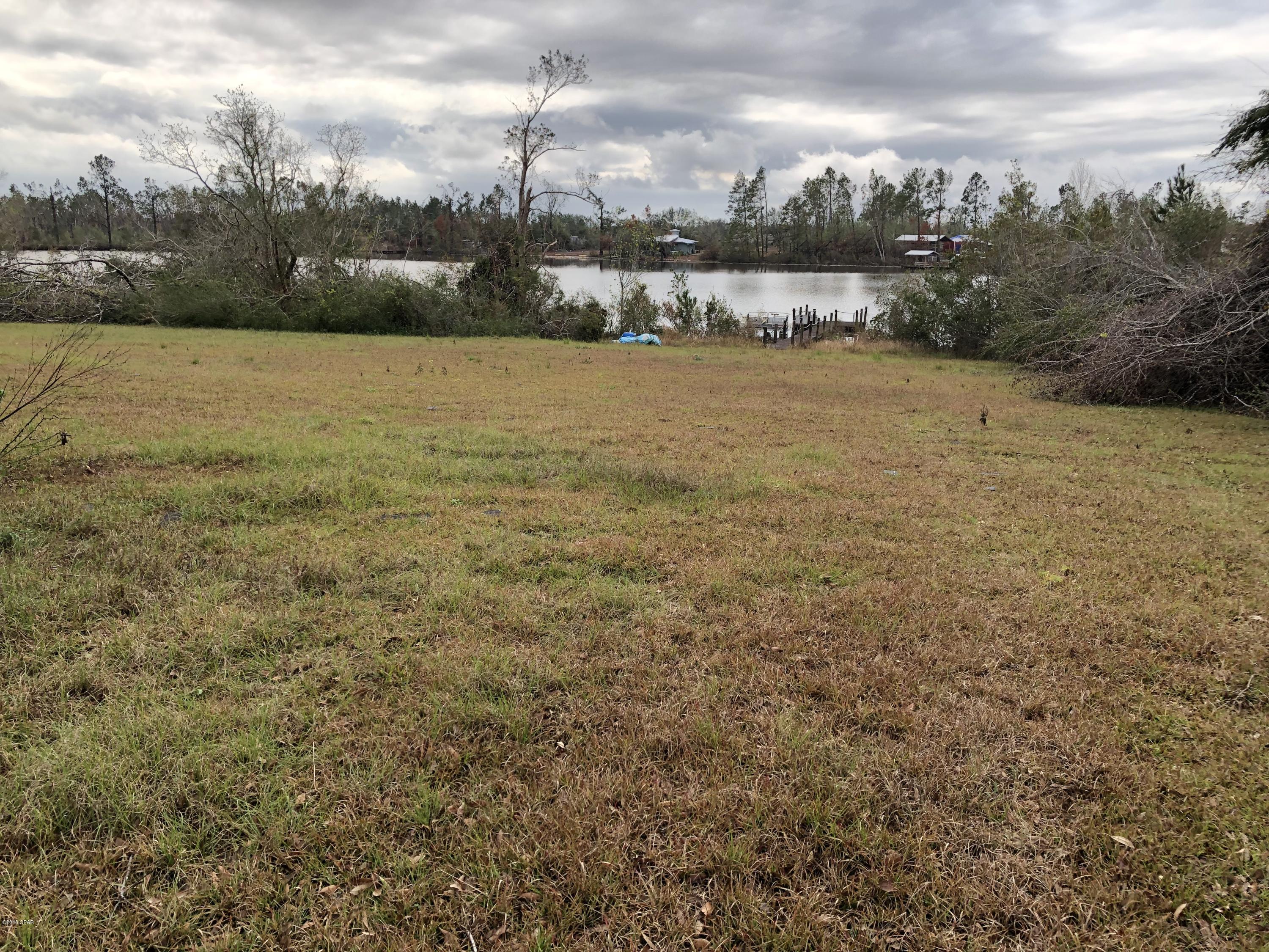Beautiful waterfront one acre lot on one of the best lakes in the area. Already a dock for your enjoyment, ready for a new single built home or mobile home. There is a septic, well and power pole.   No gas motors allowed on this spring fed lake. The lake is called Highland Lake  and it is in Compass Lake Highlands. Value in Land only, no monetary  value in mobile home and seller is in the process of moving it off the property.