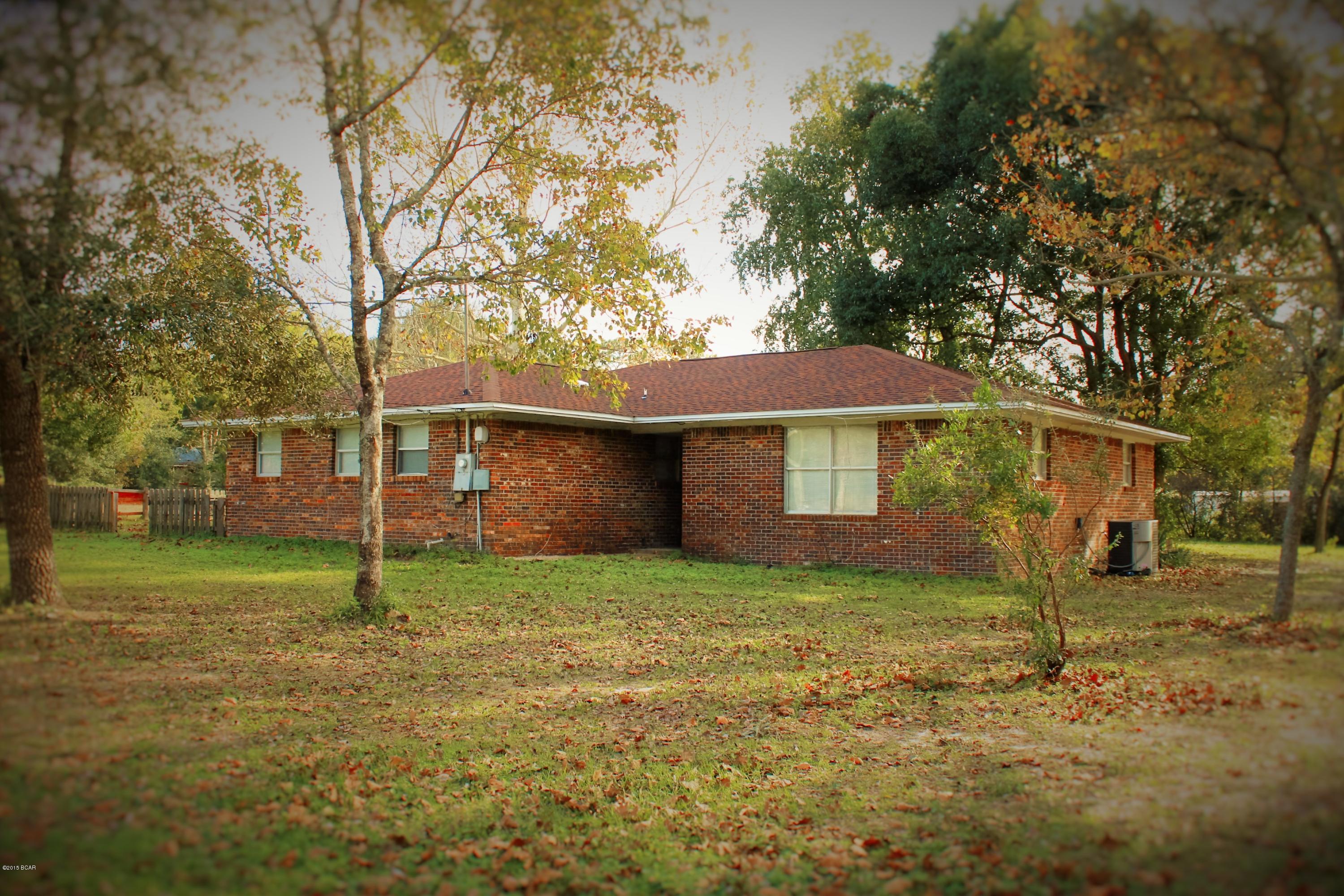 3+/2 on 2 ACRES!! Do you want to live where you have plenty of room, privacy and your neighbors can't hear your conversation?  This home boasts all of that and a brand new, just installed roof.  Come view this home with its skylights, brick fireplace and tiled floors throughout.  No cheap carpet here.  The living room has so much space for family and friends, then there is the French style doors leading to the back patio and yard with its lush landscapes and mature vegetation that all happen to be on a corner lot.  Is entertaining your cup of tea?  This kitchen has new wood cabinets, large tiled countertops, black and stainless appliances and next to it is another large room with multiple windows that can be used for socials, another bedroom or a large office. The bedrooms are good size with large closets.  The home is heated and cooled with central air and ceiling fans throughout.  Included in the sale will be 3 utility sheds that can be used as storage or workshops.  The house was remodeled in 2005, new insulation was added with a new ac in 2009 also.