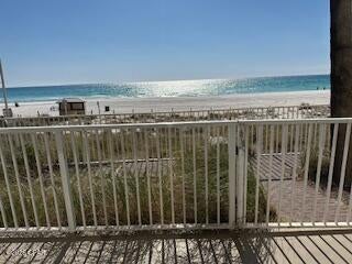 LOWEST PRICED ''U'' Floor Plan!! Experience elevated coastal living in this rare East-side corner, ground-floor premium condo offering 3 bedrooms, 3 baths, and sweeping panoramic Gulf views. Designed with the highly desirable ''U'' floor plan, this layout provide breathtaking sunrise and sunset vistas from the expansive wrap-around balcony. What truly sets this condo apart is its private gated terrace access--step directly from your balcony to the pool deck and onto the beach. 
Inside, the condo has been thoughtfully renovated and beautifully refurnished. Recent upgrades include: New granite countertops, Luxury vinyl plank flooring throughout, New sink and faucet,
Updated hanging light fixtures, Shiplap accent wall in the living area, Fresh interior paint, All new bedroom furniture and Soaring 12-foot ceilings for an open, airy feel. The functional layout features two spacious main suites, each with private baths, plus a third bedroom with its own bath--ideal for larger families or maximizing rental occupancy. A large exterior storage room just outside the front door adds additional convenience for beach gear and owner storage.

With strong rental performance, unmatched accessibility, and premium corner positioning, this condo is perfectly suited for investors seeking income potential as well as buyers wanting a spacious Gulf-front retreat. The condo conveys fully furnished and rental-ready, making it an effortless investment opportunity or turnkey beach retreat. This unit also includes one deeded parking space. 

Shores of Panama is home to the largest Gulf-front lagoon pool in Panama City Beach, with its spectacular 14,000+ sq ft zero-entry lagoon pool with palm-lined islands, fountains, and expansive hot tub. tropical palm islands, fountains, and an oversized hot tub--all just steps from exclusive beachfront access. Owners and guests also enjoy:  Indoor heated pool and hot tub, 24-hour fitness center, Seasonal poolside Tiki bar, Covered parking, and On-site security.
The location is unbeatable--walk next door to Pineapple Willy's for beachfront dining or cross the street to Laketown Wharf for multiple dining options including The Wharf Buffet, Juan Taco, and LuLu's Bar & Restaurant. Shopping, entertainment, and attractions are all within easy reach.
If you're looking for a well-positioned Gulf-front condo with proven rental appeal and unbeatable amenities--this is a standout opportunity. With exterior renovations scheduled to enhance curb appeal and long-term value, this is a strategic opportunity to secure this wonderful gulf front condo--ideal as a personal retreat, income powerhouse, or both. All information and HOA details are believed accurate but should be verified by buyers if important.