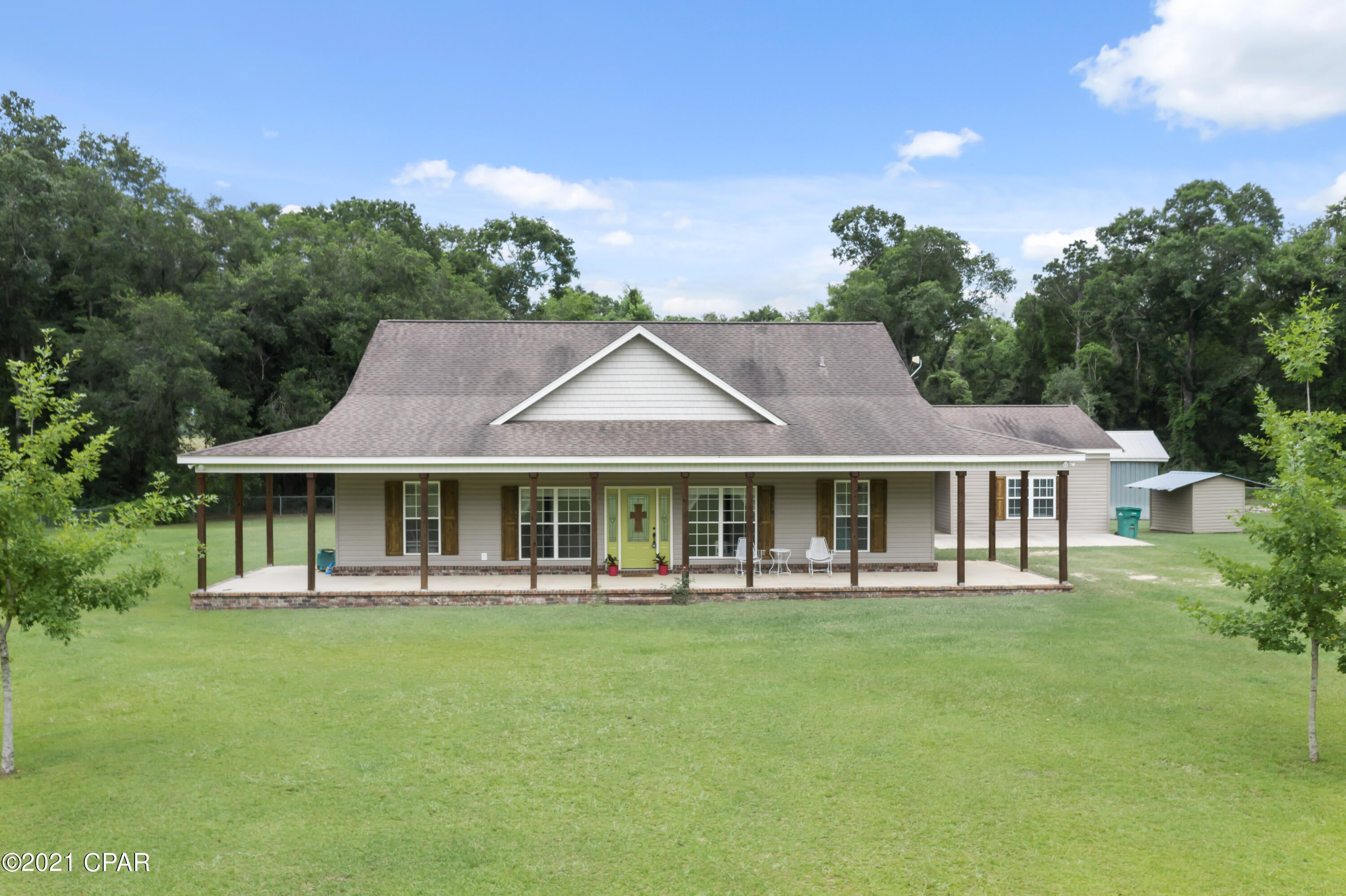 Wow!  This four bedroom home is situated on 5 acres and is nestled among the trees.  If privacy and country living are what you are looking for, this is it!  The living area of this home features an open concept.  The master suite is well appointed and features a large walk in closet and the master bath features a large garden tub, as well as a tile shower.  The home has solar panels.  The property features a large outbuilding.  This property is a must see!