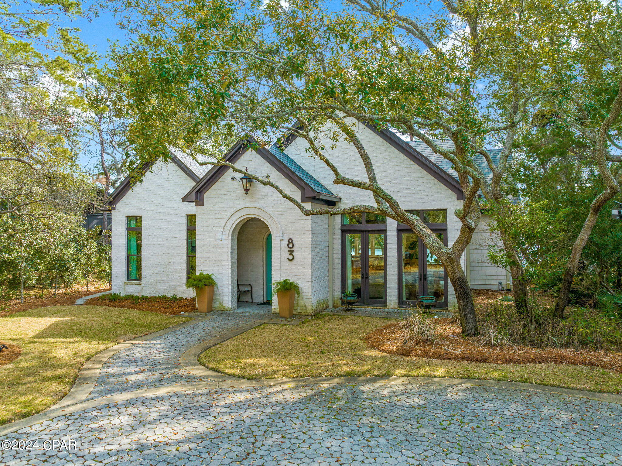'CURRENTLY UNDER CONTRACT, SELLER WILL CONSIDER BACKUP OFFERS'This pristine four-bedroom brick home offers a superb living experience in a picturesque lake front setting. Situated on a high lot overlooking Eastern Lake with 85 feet of frontage, it provides easy access to the Gulf of Mexico, either by a short paddle or a leisurely stroll. The custom multi-tiered decking enhances the outdoor living experience, creating a peaceful and beautiful environment to enjoy scenic Eastern Lake. The expansive windows in the kitchen and living areas showcase breathtaking views of Eastern Lake, framed by the unique oaks that surround the property. The house boasts a dream kitchen that is sure to delight any culinary enthusiast and is a focal point of luxury, featuring high-end appliances such as a Wolf stove, Sub-Zero refrigerator, and an Asko dishwasher. Custom-made Kraft cabinetry with automatic closures adds a touch of sophistication. The gourmet kitchen is designed for both functionality and style, providing an ideal space for cooking and entertaining.

The 1st-floor master bedroom is a tranquil retreat, complemented by a stunning master bathroom.

On the 2nd floor, there is another master suite with a private balcony, providing an additional vantage point to enjoy the scenic surroundings. Two more bedrooms on the second floor ensure ample space for family or guests.

This excellently maintained home is versatile and well-suited for various purposes, whether as a full-time residence, a vacation home, or a rental property. Its sophisticated design, high-quality amenities, and a perfect location makes it unique and ideal for a 30A Dune Lake Home. *Home is buying sold furnished including all the lake toys under the deck. Seller is removing their personal items and a few pieces of artwork and furniture. List of items excluded from sale will be provided.  Buyer to verify all information and measurements deemed important.