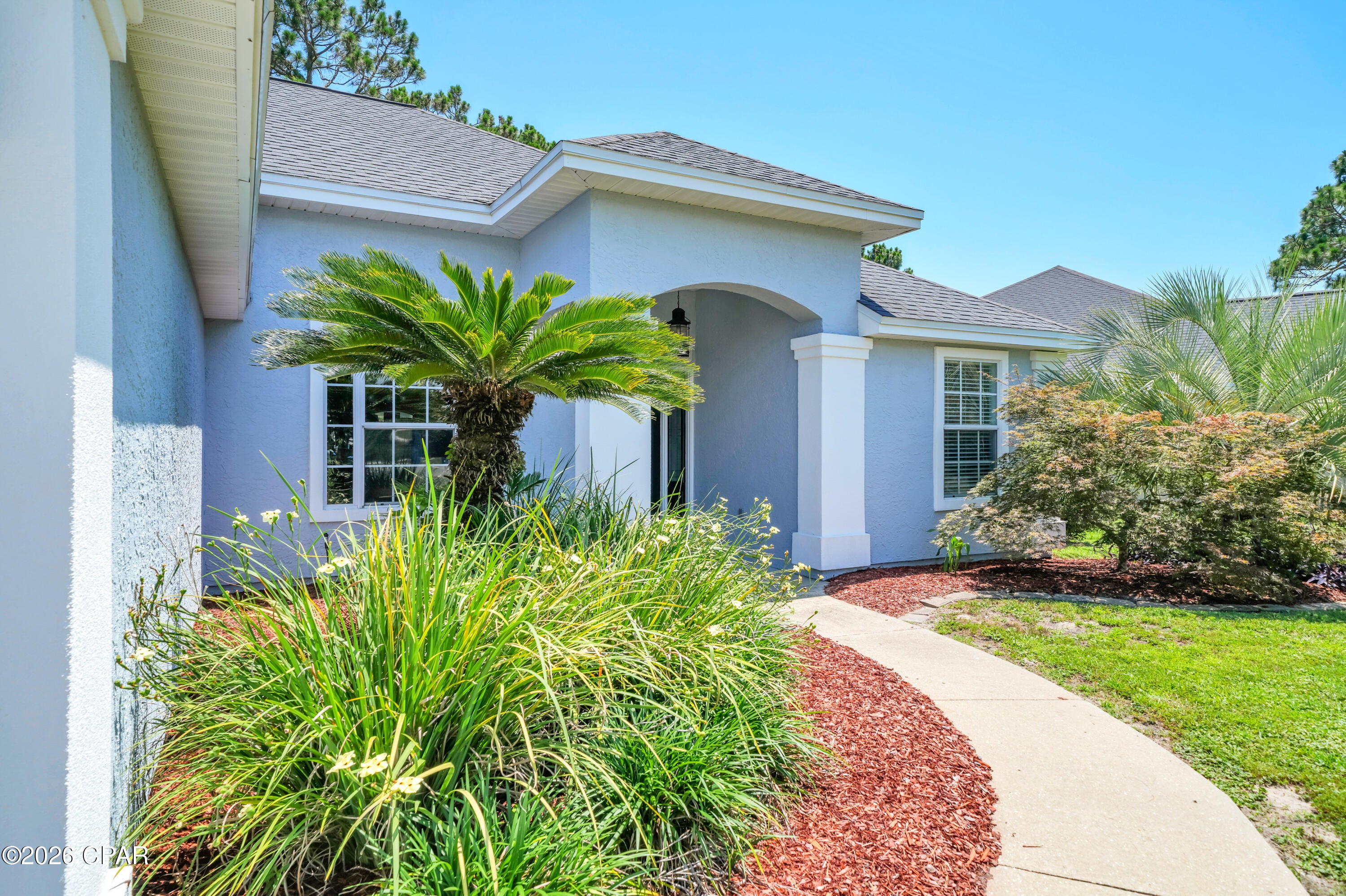Pride of ownership is taken to a whole new level in this beautiful residence in the Hidden Pines neighborhood of Panama City Beach. Lovingly and meticulously maintained by its owner-occupant for over 20 years, this immaculate home delivers a rare combination of pristine quality, thoughtful updates, and an unbeatable location with no HOA dues.

From the moment you arrive, exceptional maintenance is evident inside and out. Major exterior updates provide long-term peace of mind, including fresh elastomeric paint and updated stucco work (2024), replaced front door glass and sidelights (2021), and a 2018 roof. Inside, 1,701 sq. ft. of carpet-free living space features soaring ceilings, crown molding, fresh 2026 interior paint, brand-new lighting and ceiling fans, plus beautiful COREtec Plus LVP flooring. In addition to the 3 spacious bedrooms and 2 full bathrooms, the home includes a flexible Florida/bonus room fitted with its own newly added exterior door (2025), making it an ideal home office, flex room, or private guest space. 

The heart of the home centers around a cozy fireplace and a beautifully revamped kitchen equipped with brand-new granite countertops (2026), a sleek quartz composite sink, an under-sink water filtration system (2025), modern stainless steel appliances, updated plumbing fixtures, a dedicated dining area, and a light-filled breakfast nook featuring a newly replaced exterior window (2026). The primary suite serves as a true retreat with two walk-in closets, a double vanity, a frameless glass shower, a separate soaking tub, a newly added privacy window (2026), and upgraded toilet and plumbing fixtures. 

Outside, the property backs directly up to a peaceful, protected wooded preserve, providing a completely private backyard oasis with no rear neighbors. Enjoy the coastal breeze from your covered, screened-in porch, or take a scenic stroll along the community's convenient nature paths. Situated in a highly desired pocket of PCB just minutes from the Navy Base, premier shopping, local dining, and world-famous emerald waters, this meticulously updated home is completely move-in ready. Schedule your showing today!