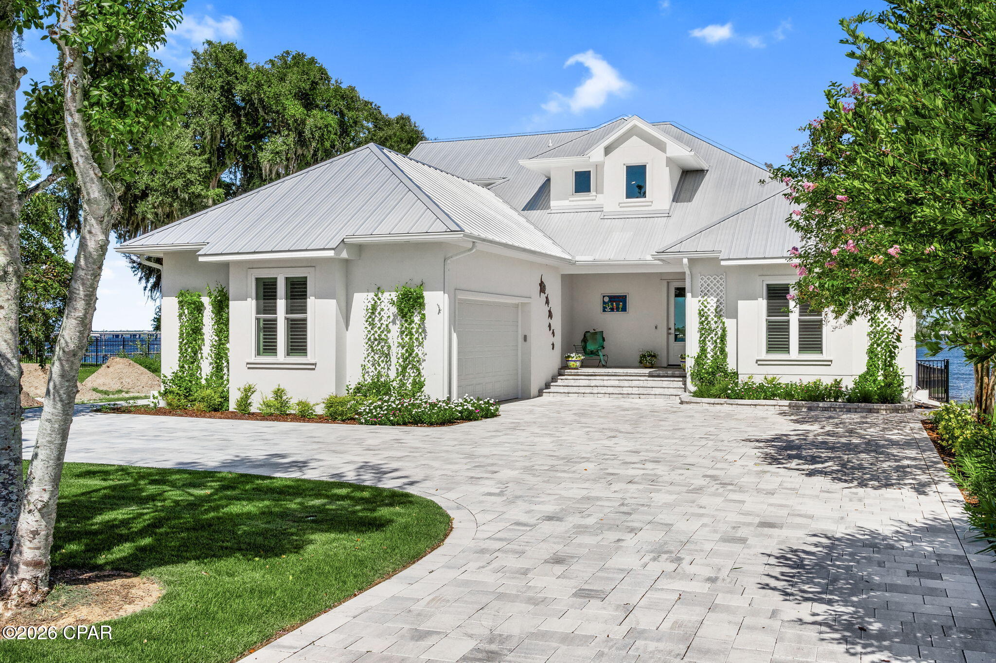 Experience refined waterfront living in this exceptional bayfront residence nestled within the highly desirable Panama City Country Club, a golf cart friendly community. 

Designed for those who appreciate quality, privacy, and the effortless coastal lifestyle, this beautifully appointed home delivers breathtaking bay views, exceptional construction, and an extraordinary boating setup--all in one remarkable property.
The property is in an exceptional location, only a few homes away from the clubhouse. 

Inside, soaring ceilings and tall doors create an impressive sense of scale, while the open-concept design allows the kitchen to flow seamlessly into the living area, creating the perfect setting for entertaining. Granite countertops, stainless-steel appliances, luxury tie plank flooring, and sophisticated finishes complement the home's elegant yet comfortable coastal aesthetic. Bay views are enjoyed from the kitchen and living room, while the front primary suite offers its own beautiful waterfront perspective--making every morning feel like a vacation.

Built with an uncompromising focus on quality and resilience, the home is constructed with reinforced concrete block, rebar, and poured-concrete reinforcement throughout. The raised concrete slab was built at an elevation exceeding building requirements. Hurricane-rated windows and doors throughout, along with additional hurricane curtains for the sliding doors, provide an added level of protection. A Generac automatic natural-gas generator offers peace of mind and convenience.

The exterior is equally impressive, featuring extensive custom paver work throughout the driveway, walkways, walls, planters, and front and rear stairs. The fully fenced backyard with black aluminum fencing and artificial turf provides an elegant, low-maintenance setting for waterfront entertaining.

For the boating enthusiast, the waterfront is truly exceptional. The seawall was replaced within the last five years, the dock features new Trex decking, and two new 6,000-pound automatic boat lifts provide an incredible setup for enjoying everything the water has to offer. Even the 2 sea doos and the new boat can be purchased separately as well!

Step outside and embrace the lifestyle--morning coffee overlooking the bay, sunset gatherings with family and friends, offshore fishing excursions, leisurely cruises, and days spent exploring Shell Island and the emerald waters of the Gulf of America.


Beautifully appointed. Exceptionally built. Uniquely positioned. This is bayfront living elevated to a level rarely found.

The golf cart will be included in with a full price offer. 


All measurements and items of importance to be confirmed by buyer or buyers agent.