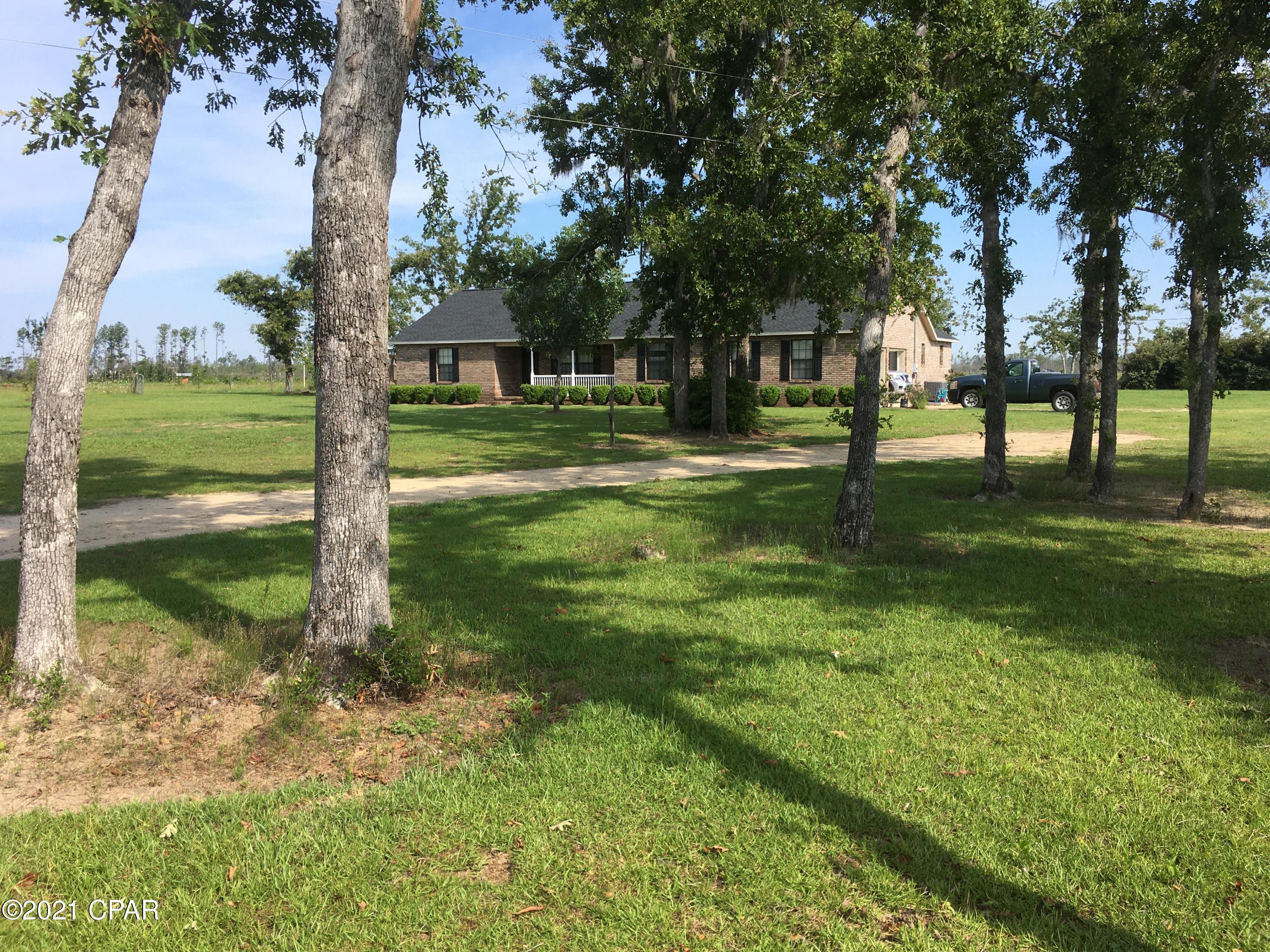 Beautifully maintained and updated 3 bedroom 2 bath brick ranch home with in-ground pool located on a private 20 acres, fenced and cross-fenced. You have horses? This is would be perfect for the Equestrian who dreams of being able to ride right from their own property. Miles and miles of dirt roads nearby, as well as a 50 minute drive to the Gulf of Mexico and Panama City Beach. The crystal clear, spring fed waters of the Chipola River are right up the road where you can spend the day fishing or kayaking until your heart's content! Like to hunt? You can do that on this property if you choose to, or just feed the deer and turkey and enjoy watching them. This is privacy and peace and quiet at it's best, yet less than a 5 minute drive to downtown Clarksville where there is a general store with gas, hot food deli, and all the necessities, as well as a new Dollar General right there in town. Clarksville has a wonderful K-8 school and Blountstown, FL is only 15 minute drive and is where there is another elementary, middle school, and high school as well as shopping, hospital, doctor's offices, banking, and restaurants. There is also a couple storage sheds and a small pole barn as well as an additional septic tank located on property. Schedule a showing and come see for yourself!