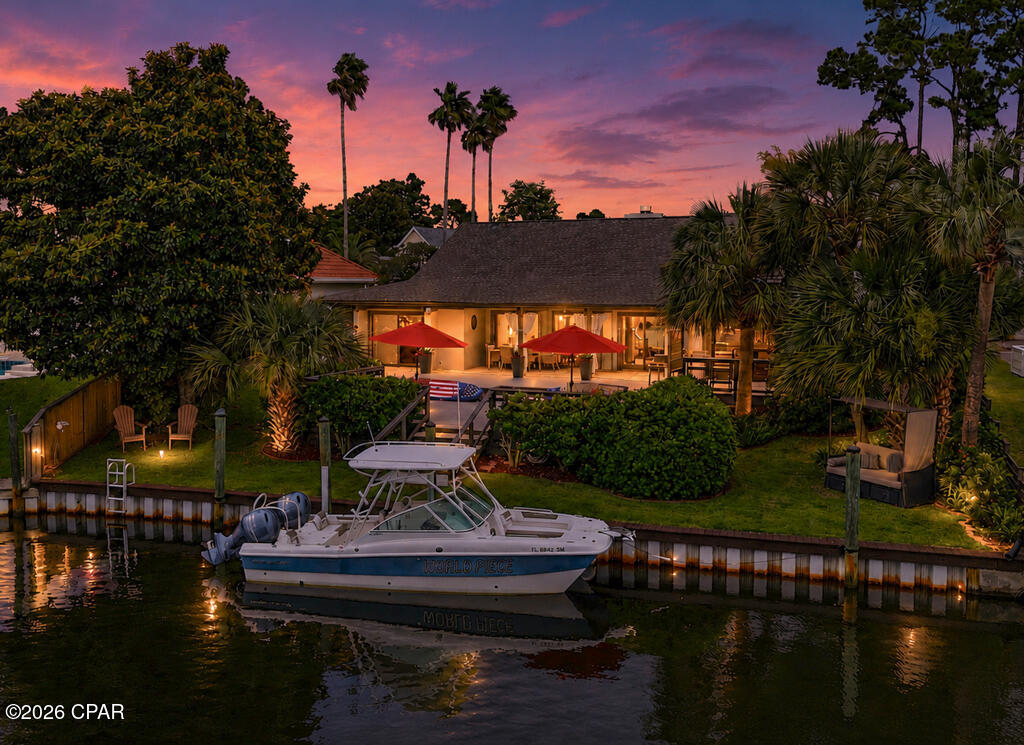 Experience elevated coastal living at 210 Marlin Circle in Bay Point--an elegantly updated waterfront sanctuary on a quiet canal east of the Bonefish Bridge. True move-in readiness meets peace of mind in this pre-inspected, one-level residence located in Zone X, featuring a clean claim history, insurable status, and a recent vinyl seawall evaluation with no issues. 

The resort-style arrival features a circular paver driveway exceeding 5,000 sq. ft., automated landscape lighting, and a striking 6-foot fountain water feature surrounded by soothing beach pebbles.  Inside, the Great Room rises to cathedral ceilings anchored by a functional gas-to-wood burning fireplace, flowing seamlessly into a wet bar with custom waterfall granite, a beverage fridge, and an ice maker. The efficient kitchen boasts updated cabinetry, soapstone countertops, upgraded KitchenAid appliances, a 6-burner natural-gas cooktop with pot filler, and convection microwave wall oven. 

Designed for ultimate versatility, the interior layout showcases four en-suite bedrooms. The primary suite features a Turkish-inspired steam shower with Delta/Ferguson dual heads, Bluetooth speakers, and mood lighting, alongside a soaking tub, dual vanities, and a private courtyard with Trex decking, a hot tub, and a dual-temperature outdoor shower. Guests or caretakers enjoy a private-entry suite with its own courtyard, frameless shower, floating vanity, and dedicated laundry zone. A third mobility-friendly front suite includes a curbless roll-in tile shower with dual fixtures, while the fourth suite offers a floating granite vanity paired with a full tiled tub and shower combo.

The fenced back yard with lush Zoysia turf serves as your launchpad for deep-water adventure. Positioned on approximately 70 ft of waterfront, the private dock was upgraded in 2019, with a new seawall cap, pilings, and ladder.  In addition to,  30-amp shore power, watercraft washing stations, and zero height restrictions--offering uninhibited passage to Shell Island and the Gulf for tall-masted sailboats, flybridge yachts, or tuna towers. There's even a spot for a boat lift! Multiple entertaining and relaxation areas aligned toward western-facing sunsets let you connect and unwind in total serenity with space for a swimming pool! 

Behind the scenes, mechanical and building infrastructure is entirely turn-key. Upgraded dual HVAC systems with replaced ductwork (2020) feature semi-annual service history and REME HALO® air purification. The 2020 natural gas installation feeds two annually serviced Navien tankless water heaters, cooktop, fireplace, primary laundry, and an outdoor stub for a future fire pit or grill. Additional features include a 2019 roof, gutters, a complete chimney overhaul (cap, chase cover, flue pipe, and collar), storm drain system, dual laundry zones including a boater's closet, smart Honeywell thermostats, Orbit B-hive irrigation, and integrated surround sound with global surveillance access.

Every system is checked, completed, and move-in ready. Schedule your private showing today.