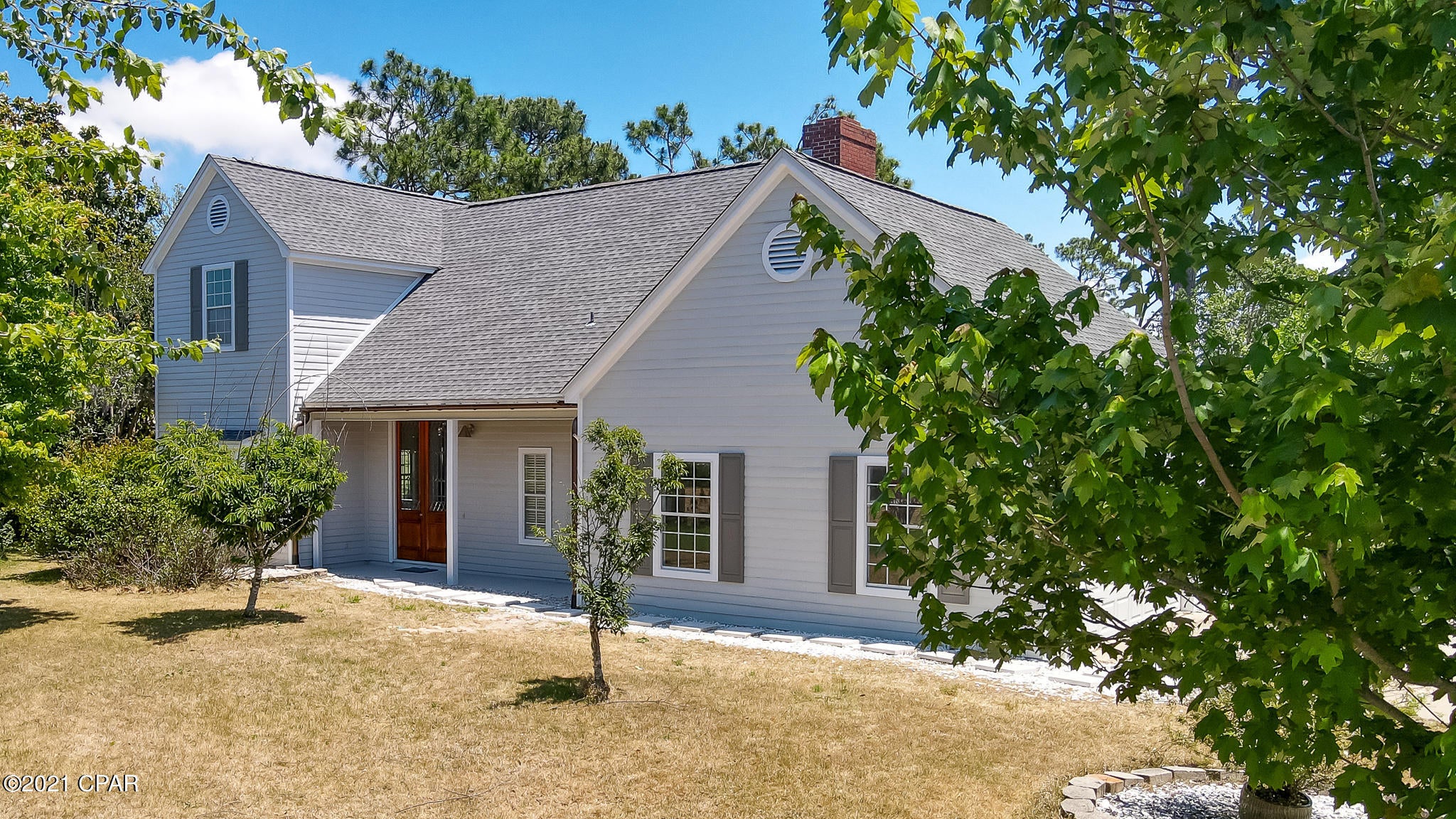 CURRENTLY UNDER CONTRACT, SELLER ACCEPTING BACKUP OFFERS! - Come visit this very special Cape Cod style home in the gated community of Bay Point, Panama City Beach, Florida that offers 3 Bedrooms, 2 full Baths and 2 half baths.  All sleeping areas are located upstairs with cheerful morning sunshine views and several choice entertaining areas on the main level, including a wood burning fireplace in one of the sitting areas. Spacious open concept kitchen with granite countertops and gas stove, lots of cabinets, and stainless refrigerator. The large foyer is introduced via stately beveled glass doors where you then view the stunning wooden stairway leading to the Master suite and the two guest bedrooms and guest bath.