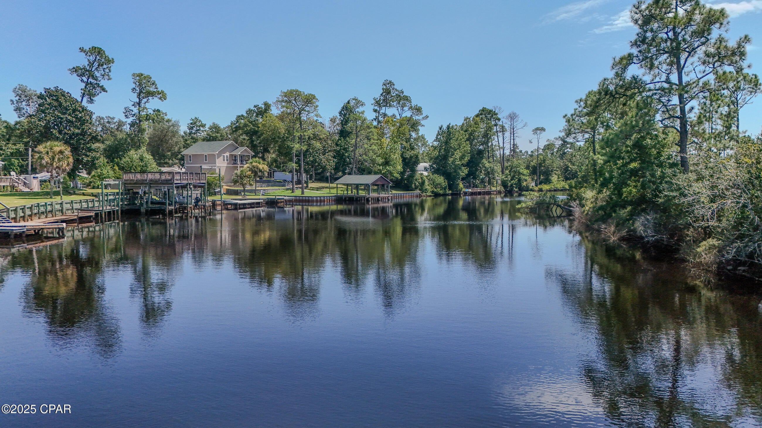 Outdoor Living, boating and serene waterfront ambiance. Bring your architect or builder and imagine a design that takes full advantage of the setting, with its privacy, frontage, well access, and scenic serenity, this parcel represents both a peaceful sanctuary and a practical investment. Deep water access for a dock or boardwalk on Burnt Mill Creek to access West Bay and Gulf of America.  Also, a public boat ramp less than a mile for use.
