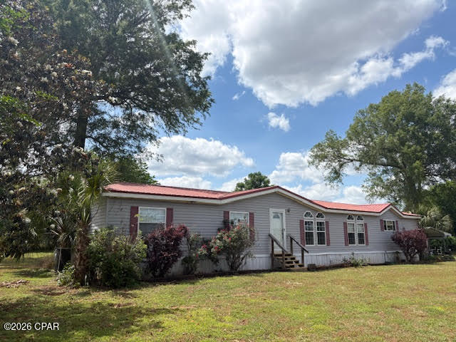 Discover the possibilities with this 10.33-acre property offering space, flexibility, and a prime location along a major four-lane highway with convenient access north toward Montgomery and south to the Gulf Coast beaches.  The property features a well-maintained 4-bedroom, 2-bath doublewide mobile home with 2x6 exterior walls and a desirable split-bedroom floor plan. Inside, you'll find a spacious kitchen and dining area with abundant cabinet and counter space, plus a cozy wood-burning fireplace in the living area. The large primary suite includes a walk-in closet, jetted tub, separate shower, and double vanity. Two additional bedrooms also offer generous walk-in closets.  Outdoors, enjoy established fruit trees--including peach, pear, chestnut, mulberry, and apricot--supported by dedicated water lines. Additional improvements include a storage building and a metal carport that can also serve as a covered outdoor entertaining space.  A 2006 3-bedroom, 2-bath singlewide mobile home is also on the property and may remain with acceptable terms or be removed prior to closing.  For those seeking even more space, an adjoining 10-acre parcel with a brick home and large barn with stalls is available for purchase (see MLS 789294). This property presents an excellent opportunity for a family compound, hobby farm, or investment.