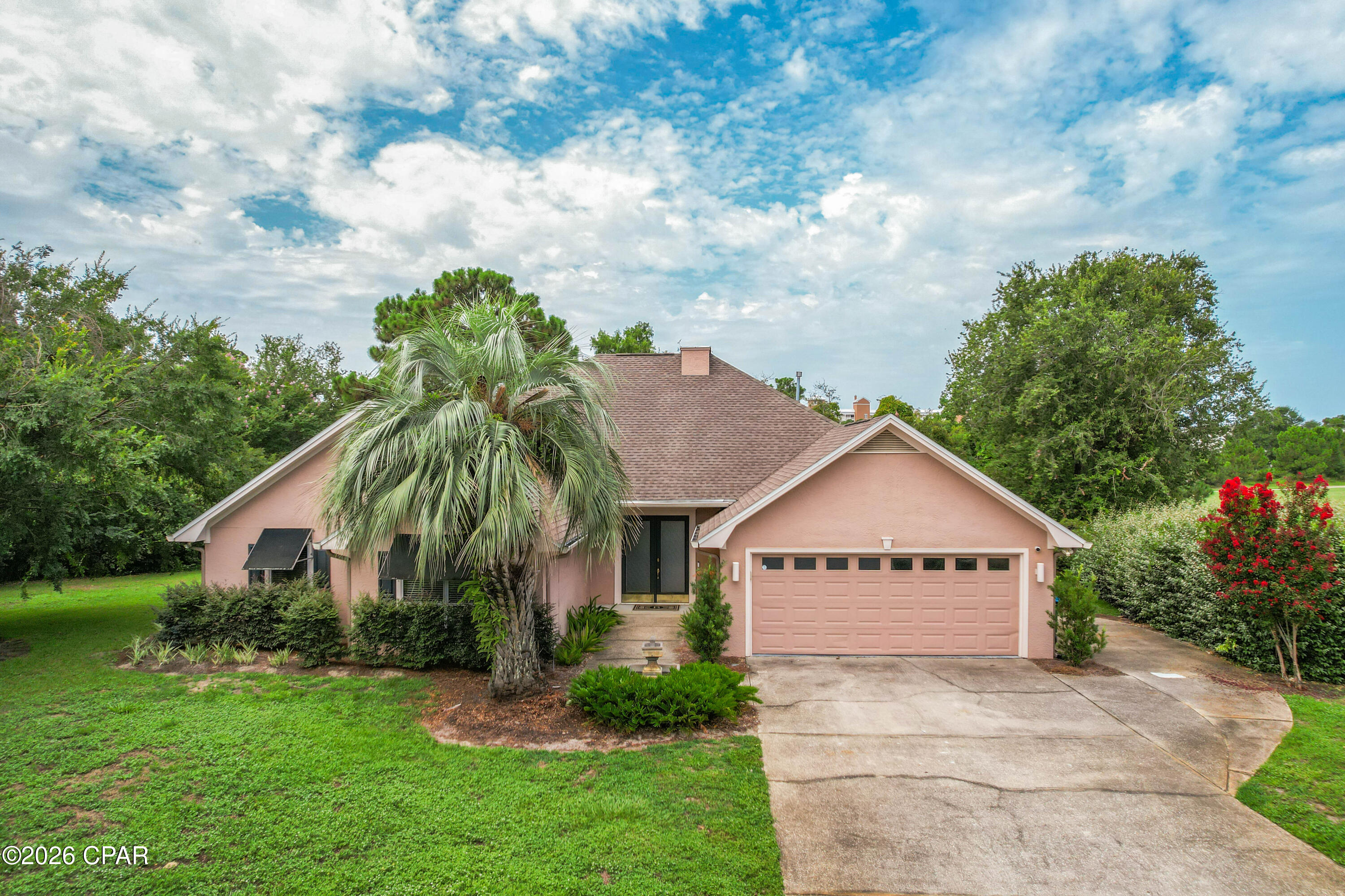 **Seller offers up to $10,000 toward buyer closing costs with acceptable offer!** Tucked away on a private cul-de-sac in the desirable Legend Hills neighborhood of Bay Point, this 3 bedroom, 2.5 bath home offers peaceful golf course living. Set along the 14th tee box, this beautifully situated home offers a large homesite with a spacious side yard, mature trees, and a tranquil setting that feels both open and private. Inside, you'll find tall 12' ceilings, crown moulding, and a thoughtfully designed floor plan featuring a formal dining room and an inviting living area centered around a beautiful fireplace. The spacious primary suite with vaulted ceilings is complete with an ensuite bathroom featuring a double vanity, dedicated beauty vanity, oversized walk-in shower with a rainfall shower head, and a custom walk-in closet with built-in storage. Surrounded by mature trees, the oversized cul-de-sac homesite offers exceptional privacy. A huge side yard provides plenty of room to relax, play, or create your own outdoor oasis. The expansive back deck is both covered and open, is the perfect place to entertain guests or unwind while taking in the tranquil surroundings. Additional highlights include an oversized 2-car garage with golf cart door entry, offering convenient access to the golf course and community amenities. Residents of Bay Point enjoy the security of a gated community with 24-hour security, while being just minutes from Point South Marina, Bay Point Golf Club, waterfront dining, shopping, and some of Panama City Beach's best restaurants. Bay Point Golf Club is the only Nicklaus Design golf course in Northwest Florida. With 18 holes of Championship Golf, Bay Point Golf Club is one of the top resort destinations along the Emerald Coast. Combining privacy, generous outdoor space, and an unbeatable location, this home offers an exceptional opportunity to enjoy the Bay Point lifestyle. AC 2025. Gas water heater is new. Buyer to verify any information deemed important.