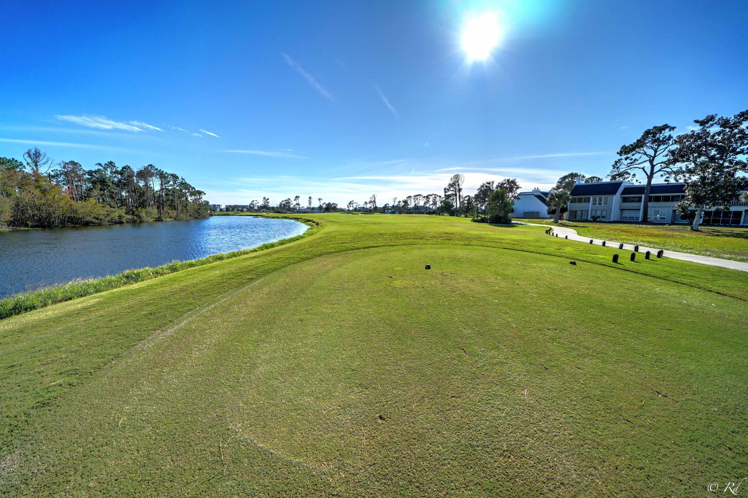 THE VIEW!!!!! Beautiful condo in a picturesque setting in an upscale, gated community. This is an end unit, with only one neighbor. The views from this 2nd floor condo are truly mesmerizing. Not only is there a view of Jack Nickolaus Golf Course but the amazing lakes on the course. New flooring & painting, windows, hot water heater &  new roof. If you'd like a move in ready condo, this one is for you. In addition to Condo fees there is an annual Bay Point fee of $1325.