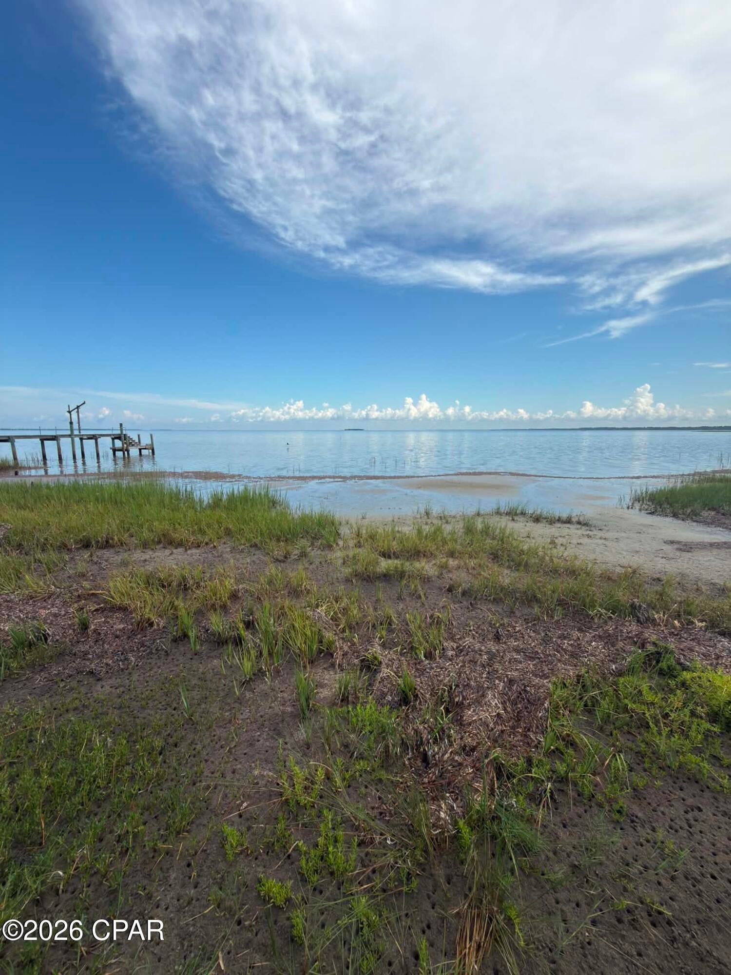 Platted bayfront building lot with outstanding views of the head of St Joseph's Bay and Black's Island. This lot has minimal marsh grass in front of it and therefore would have easier access to scalloping, kayaking, paddle boarding and small craft boating. Easy access to Salinas Park for legal driving access to the beach and all of the south Cape. Lot is currently not subject to the Villa Del Sol HOA and was pulled out of the development years ago. A portion of the flood zone is AE and VE. The Villa Del Sol HOA would consider membership for access to amenities. Some dimensions were obtained via the Gulf County Property Appraiser's website. Please verify if important. Dock is not included.
