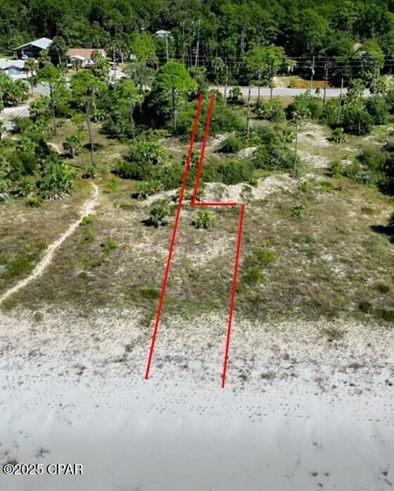 Looking for a rare beachfront opportunity with privacy, low flood insurance potential, and strong short-term rental appeal? This 'Diamond in the Rough' 0.60-acre gulf front lot checks all the boxes. The driveway is 10' x 264' that opens into remainder of lot at 52' x 400', where the home would sit and in similar alignment with other gulf front homes. This area is level and ready for your plan. The lot widens to 62' at waterfront. Situated in Gulf County, this parcel offers an ideal build site in the A Flood Zone, access to miles of sandy shoreline, and unique neighboring protection from development—making it one of the most compelling gulf front lots on the market today. Enjoy direct access to the beach and unobstructed sunset views from your future home. The vacant bordering lot to the west is owned by the State Buffer Preserve, offering natural buffer and added seclusion that many buyers seek. The property is noted to be in a FEMA eligibility area, an important consideration for financing and mitigation planning. Gulf County has pet friendly beaches and allows pets on leashes. Close to Indian Pass boat ramp (˜3 miles). Salinas Park (˜1 mile west) and features pickleball courts, playground, screen house, fire pit, and a boardwalk on the bay—perfect for families and active lifestyles. Dining and groceries a short drive away. Long stretches of shoreline for walking, shelling, fishing, and picture-perfect sunsets. This lot is waiting for you to build your dream beach home!!