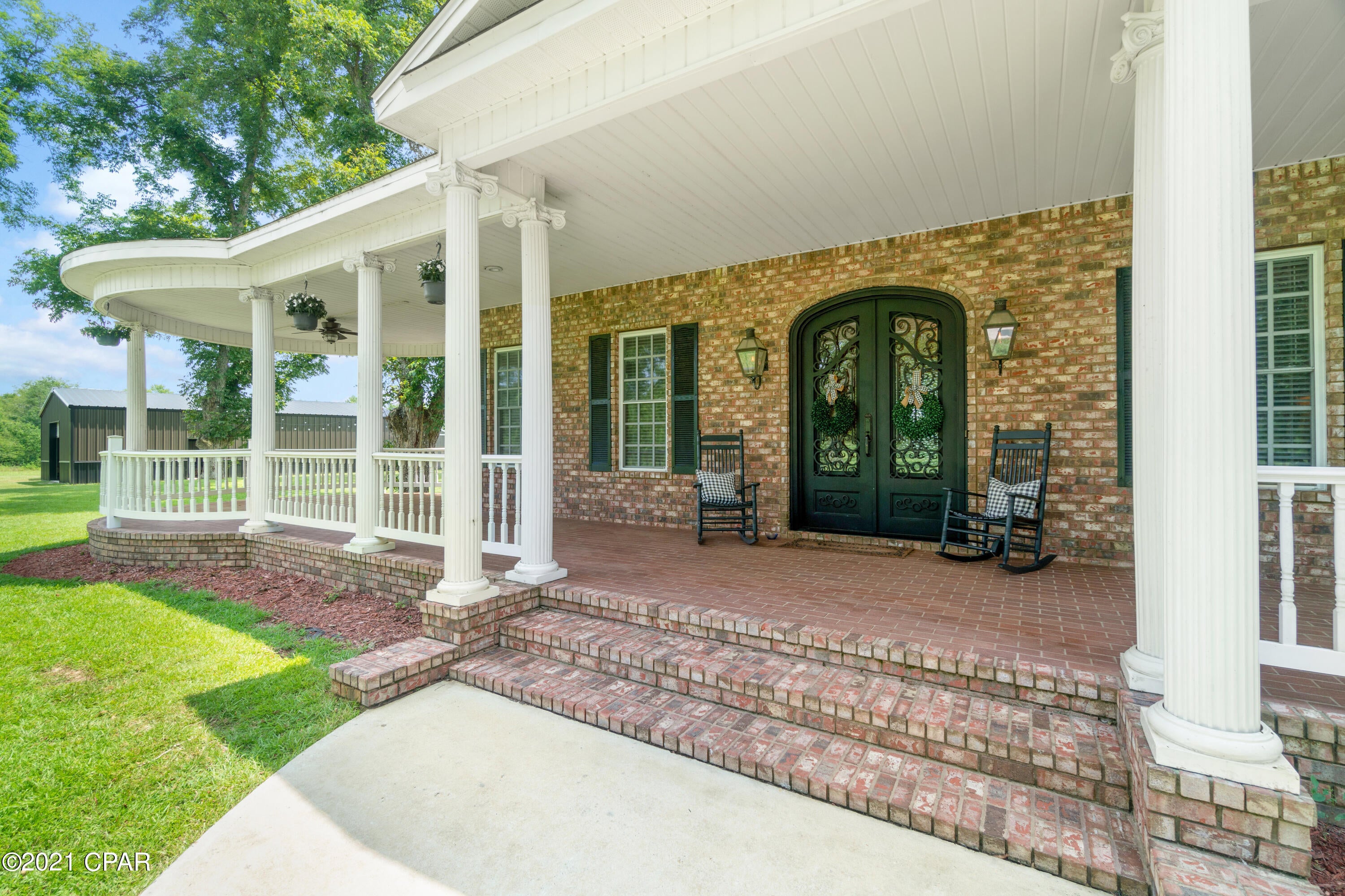 Luxurious Full 2  Story Brick Home situated on 15 acres offering natural beauty, astounding views, trophy wildlife, ponds and complete privacy. From the inviting front entryway, the custom Bevolo gas lights create the perfect ambiance. As you get closer it's hard to not notice the beautiful high impact iron front door that can withstand hurricane force winds. The 10 foot ceilings with crown molding give the home an open floor plan while still allowing each room in the home to be distinctively its own. The wood and antique brick pavers throughout the first floor makes every inch of this home unique and shows it has been well-designed and beautifully styled. You will love in the spacious kitchen that is the heart of this home with commercial grade appliances ,custom cabinets and granite countertops. There is plenty of space for the family here to make memories while making a feast with the large gas stove that features 6 burners and a griddle surface and double oven or bake your favorite desserts in the built in electric oven with a warming drawer and microwave. The kitchen island allows for extra storage while also housing an ice maker, small sink, and a breakfast bar. The sub-zero refrigerator and pantry space make your future family feasts possible to make and enjoy in the spacious dining room! You can also have a quick bite in the lovely breakfast nook. The open living room by the kitchen is the perfect place to hang out or relax and enjoy a movie with the built- in entertainment center with a gas fireplace and a surround sound system. The large master bedroom is its own special retreat to relax with a gas fireplace or in the master bathroom with the jacuzzi bathtub. The first floor also features a den/office, mudroom/laundry room with a Dutch door, and 2 car garage with storage. There are 2 staircases to access the second floor, which boasts 9 foot ceilings, crown molding throughout and a second master suite, along with 2 bedrooms and a bathroom with a large closet. There is also a bonus room that can be used as a game room or spare room, as well as 2 separate walk-in attic access locations for additional storage. Cool off in the swimming pool outside while enjoying  The property also has a steel shed that houses the pool pump and water pump for the well that is tapped into a running stream, as well as a large Red Iron Barn that can withstand 145 mph winds and double as an extra game room. Fish in the well stocked fishing pond in your backyard or cool off in your private swimming pool. You can enjoy rural living while only an hour drive to the beautiful Gulf of Mexico or being 40 minutes from Dothan. This is a rare find. Don't miss your chance to own. Call today to schedule your private tour!