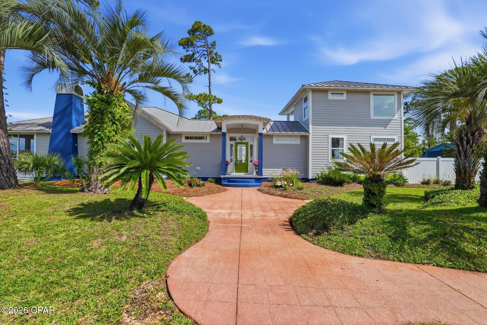 Welcome to this beautifully updated coastal home in the heart of Port St. Joe. Offering 4 bedrooms, 3 bathrooms, and 2,276 square feet, this exceptional property is located just one block from St. Joseph Bay and minutes from downtown, combining modern comfort with the relaxed lifestyle of Florida's Forgotten Coast. Inside, you'll find a bright, open-concept floor plan featuring custom built-ins, luxury finishes, wide-plank flooring, and abundant natural light. The spacious kitchen is designed for both everyday living and entertaining, with custom cabinetry, granite countertops, stainless steel appliances, a large center island, and ample storage. The adjoining living and dining areas create an inviting space for gathering with family and friends. The split-bedroom layout provides privacy and functionality. The primary suite features a large custom walk-in closet and a beautifully appointed bath with designer tilework, a soaking tub, and a walk-in shower. Three additional bedrooms and two updated guest baths offer comfortable accommodations for family and visitors. Outdoor living is equally impressive. Relax on the expansive covered and screened front porch while enjoying refreshing bay views and breezes. The large private backyard retreat features a sparkling in-ground pool, spacious pool deck, privacy fencing, and a covered patio perfect for outdoor dining, entertaining, or unwinding after a day on the water. Situated on two beautifully landscaped corner lots with rear alley access, mature palms, native plantings, this home offers outstanding curb appeal and a true coastal atmosphere. Enjoy convenient golf cart friendly access that is less than a mile to downtown Port St. Joe's shops, restaurants, marina, and waterfront parks. Cape San Blas and St. Joe Beach are just a short drive away. Whether you're searching for a primary residence, vacation home, or investment property, this coastal retreat offers an exceptional location and lifestyle.