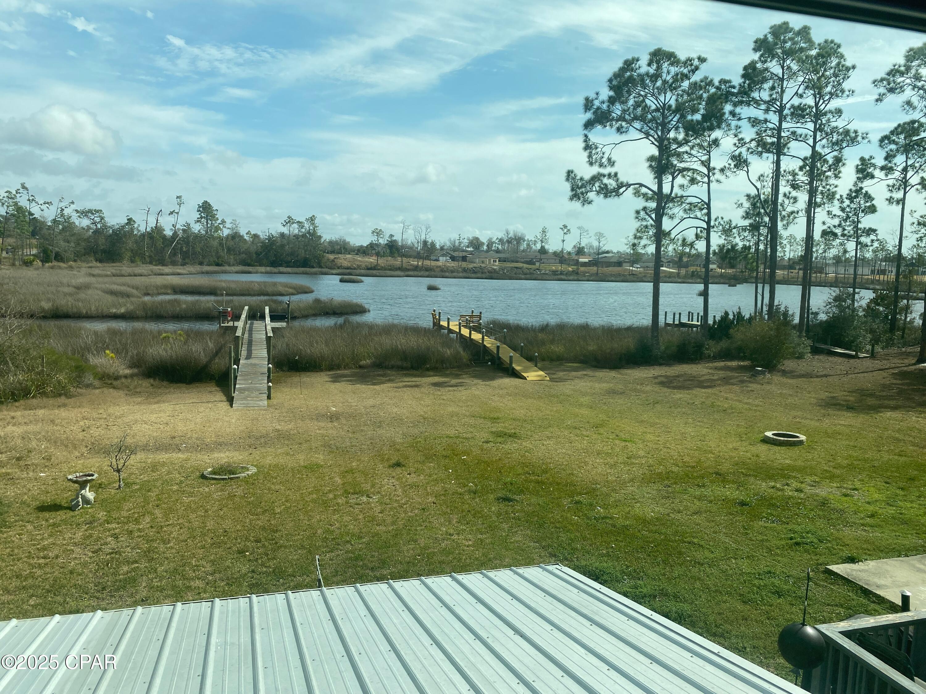 Seller says, 'Bring All Offers!' 
With an acceptable offer, Seller will provide a $10,000 credit to Buyer at closing to use at Buyer's discretion.  This waterfront gem is waiting to be discovered. Sold fully furnished, including appliances, linens, towels, and kitchen essentials, this home offers a rare turnkey opportunity. Just bring your clothes and toothbrush and begin enjoying the coastal lifestyle from day one. Recently renovated and move-in ready, this home features a brand-new roof installed after the hurricane, updated cabinetry, beautiful granite countertops, and stainless-steel appliances in the kitchen and dining area.
Inside, you'll find plush carpeting in the guest bedrooms, while the primary bedroom and main living areas showcase attractive 8-mil luxury vinyl plank flooring. Fresh interior and exterior paint provide a bright, clean feel throughout the home.
The outdoor living space is equally impressive, featuring tasteful landscaping, two raised garden beds, and a spacious 22' x 12' covered porch perfect for entertaining, relaxing, or enjoying your morning coffee.
The true highlight of the property is the private waterfront setting. A 70-foot walkway leads to a 16' x 12' dock complete with solar-powered lighting, creating the perfect spot for fishing, boating, wildlife watching, or simply taking in the peaceful water views.

Don't miss this exceptional opportunity to own a beautifully updated waterfront retreat with immediate enjoyment and lasting value.