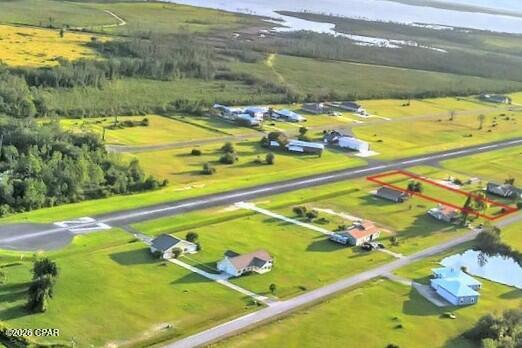 CURRENTLY UNDER CONTRACT, SELLER WILL CONSIDER BACKUP OFFERS. Are you a pilot looking for the ideal blend of functionality, coastal lifestyle, and aviation convenience?  Come discover the exclusive, gated fly-in community of Sandy Creek Airpark, and the luxury of flight centric living. 

This expansive, cleared, 3/4 acre homesite offers direct runway access and provides the perfect canvas for a custom-built residence with an integrated or detached private hangar. Design seamless aircraft storage and maintenance directly into your living space. Underground utilities, public water and sewer, paved streets, and low HOA dues.  

This lot allows you to enjoy effortless flight directly from home...an unparalleled convenience that transforms aviation from a hobby into a privileged daily opportunity. Located on 138 acres in the East Bay Sector of Panama City, Florida, this premier fly-in airpark, identified as FAA 75FL on the New Orleans sectional chart, features a 3,200' X 60 paved runway (9/27) with dusk-to-dawn lighting and a green-white beacon.

You'll enjoy privacy and tranquility sequestered away from the urban center. When you venture out, this location provides convenient access to Panama City, Tyndall Air Force Base, and the white-sand beaches of the Emerald Coast. Just a few miles away you'll find shopping, dining, boat ramps, and local marinas for boating enthusiasts.

Experience the rare freedom of flying directly from your home for business or pleasure, while enjoying the benefits of coastal living!