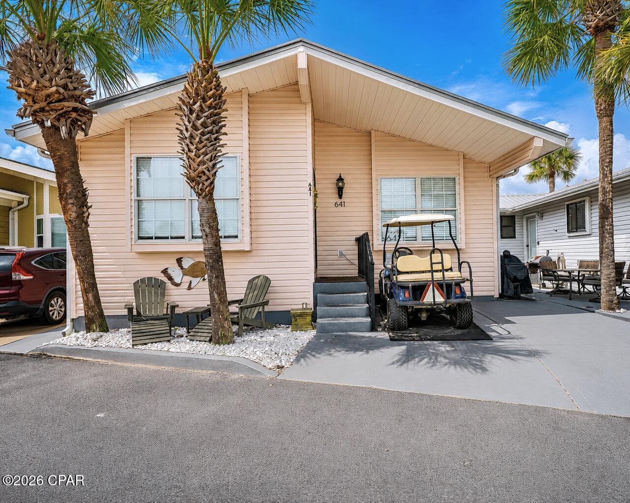 Welcome to your coastal retreat in the highly sought-after Venture Out at Panama City Beach! This spacious 3-bedroom, 2-bath home offers an open, inviting floor plan with vaulted ceilings and plenty of room for family and guests.

The bright kitchen features white cabinetry, granite countertops, stainless steel appliances, a center island  and abundant storage, all opening seamlessly to the living and dining areas. The spacious living room offers comfortable seating and a coastal feel, while the adjoining dining area provides the perfect gathering space after a day at the beach.

Outside, enjoy a paved parking and outdoor area surrounded by beautiful palm trees, giving you plenty of space to relax and enjoy the Florida lifestyle.

Best of all, this home is being sold FULLY FURNISHED and includes a GOLF CART, making it truly turnkey and ready for immediate enjoyment or use as a vacation rental.

Located in Venture Out, one of Panama City Beach's most desirable gated golf-cart communities, owners and guests enjoy incredible resort amenities including private Gulf beach access, two swimming pools, tennis and pickleball courts, basketball, shuffleboard, playground, fishing pier, boat launch and marina access, and 24-hour gated security.

Whether you're searching for a primary residence, beach getaway, or investment property, this 3-bedroom home offers the space, furnishings, golf cart, and resort lifestyle you've been looking for. Pack your bags and start enjoying Venture Out from day one!