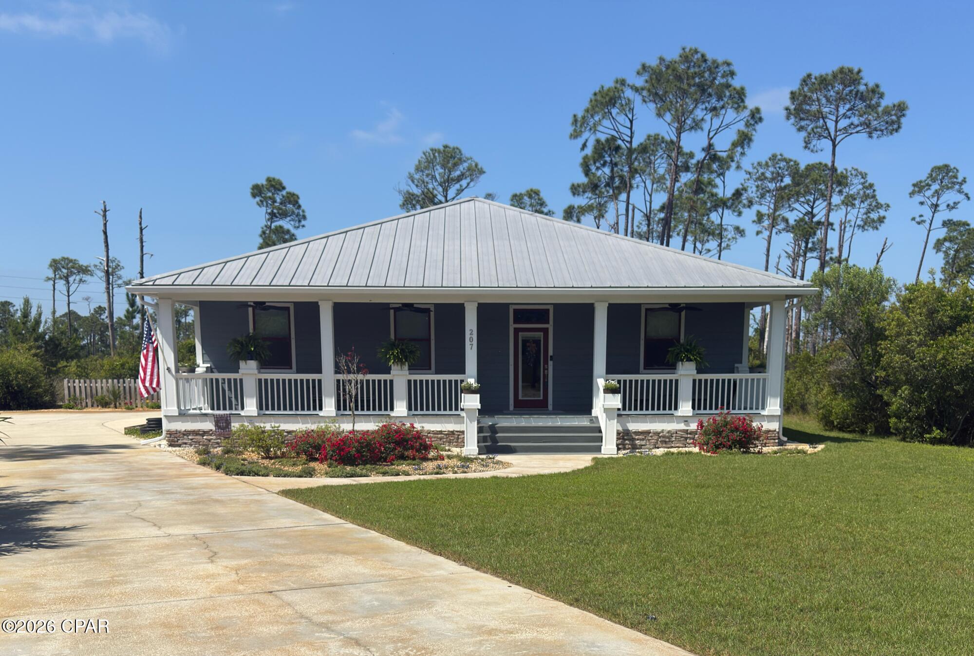 Land and Sea package! 21' Carolina Skiff included contingent on agreed upon price.  Enjoy coastal breezes from the covered front porch or unwind on the oversized screened-in patio of this beautifully designed coastal retreat at Sunset Village. Perfectly positioned on a generously sized homesite just minutes from Mexico Beach and a short stroll or golf cart ride to a county-maintained beach access, this home offers the ideal blend of relaxed Gulf Coast living and refined comfort. Spanning over 2,000 square feet, this single-story residence features a thoughtfully designed open floor plan with three bedrooms and two baths. The inviting main living area is anchored by a cozy gas log fireplace and filled with natural light, flowing seamlessly into the dining space and a custom kitchen designed for both style and function. The well-appointed kitchen boasts a spacious breakfast bar and island, double pantry, and, custom cabinetry, perfect for everyday living and entertaining alike. The split floor plan provides privacy and flexibility, with two bedrooms and one bath on the easterly side of the home, while the primary suite is tucked away on the westerly end and features a walk-in closet, ensuite bath, and direct access to a private covered and screened-in patio, an ideal space for outdoor entertaining or quiet relaxation. You will also love the library nook for reflection. A double garage and separate golf cart garage offers many storage options. Outside, the expansive and irrigated property provides both privacy and room to enjoy the natural surroundings, with a fenced back yard and open natural spaces for enjoying the coastal breezes. Located just five minutes from Mexico Beach and five miles from Port St. Joe, Sunset Village offers a peaceful setting with convenient access to white-sand beaches, boating, dining, and the laid-back lifestyle of Florida's Forgotten Coast. Flood Ins-$984, Wind/Fire-$1865. Some dimensions obtained from the Gulf PA site please verify if important. Updated photos added to show driveway/sidewalk after cleaning.
