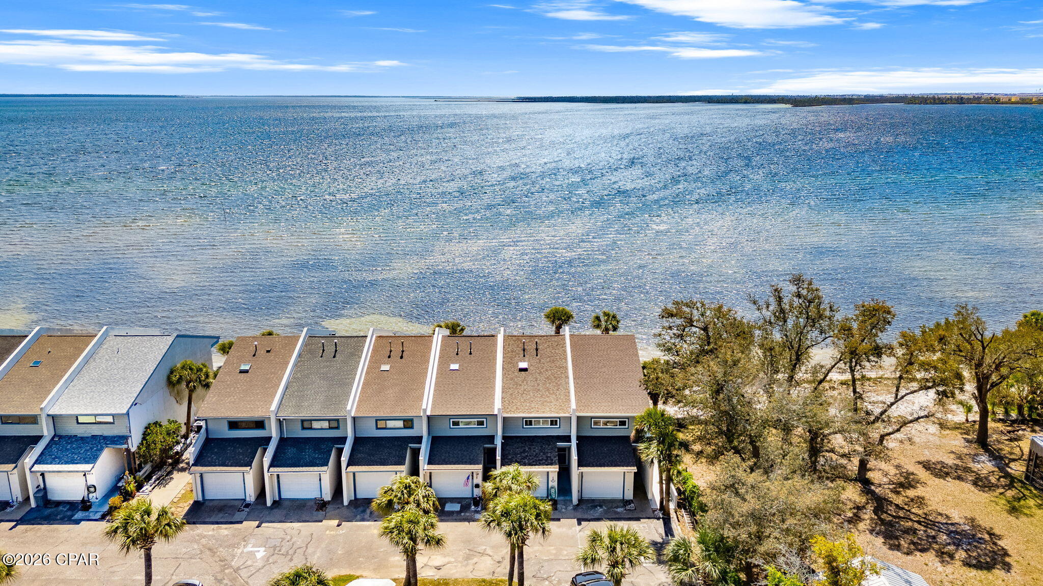 BEST PRICE ON THE MARKET WITH OPEN BAY VIEWS! Welcome to Sunbay Townhomes, a rare chance to own a versatile property with prime visibility and beautiful water views in Panama City. Perfectly positioned along a high-traffic corridor, this property offers endless potential whether you're looking for a primary residence or second home. Enjoy stunning sunrises over the water and the convenience of quick access to Tyndall Air Force Base, shopping, dining, and downtown Panama City. Inside, the home features a functional layout ready for your personal touch. Large windows invite in natural light and showcase the peaceful surroundings, while the outdoor space offers plenty of room to relax, take in the coastal breeze while you walk on the beach, or toss your kayak in for a ride. Whether you're an investor, business owner, or homeowner looking for a property with character and potential, this one checks all the boxes. Don't miss your chance to own a piece of the coast with high visibility and endless possibilities, book your private showing today. Sorry, NO Short Term Rentals.