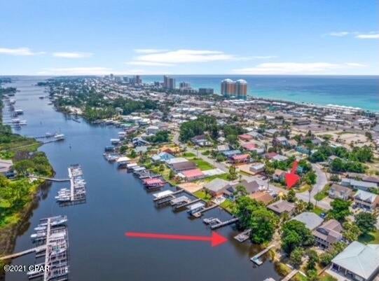 Waterfront Home on South Lagoon!  Boat dock with boat house option and two WaveRunner lifts. This sportsman's  paradise has easy boating access to the gulf, St. Andrews Bay and Shell Island. From your dock catch red fish and watch the dolphins play. It's a birdwatching sanctuary. Walk to your public beach access. Golf cart friendly community. Close to favorites - Captain Anderson's restaurant and Schooners. Convenience with the bliss of natures finest offerings. Vacation rentals are welcome. No HOA. Washer/ Dryer hook ups are plumbed for upstairs and downstairs.
(all measurements and dimensions are approximate and need to be verified by buyer if deemed necessary