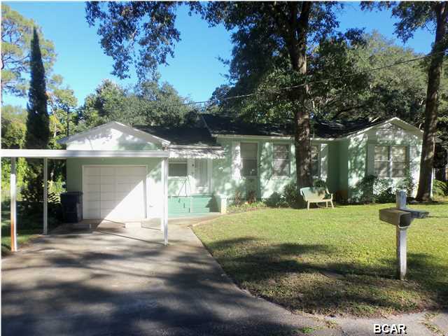 COVE CUTIE!! This spacious 2BR home offers good sized rooms (8.5' ceilings) with bigger home feel. Updated kitchen and newer than original windows...Present owner recently inherited from ''one and only'' original owner since new...Entry Foyer leads to family/den separated by french doors to large L-shaped living/dining rooms. Kitchen features contemporary cabinets and appliances with eat in breakfast nook overlooking big back yard. Covered entry porch, off carport, good size garage with laundry hook ups (washer/dryer negotiable), w/shower in garage to cool off from those outdoor chores. Intriguing oversized lot with lazy creek thru sloped rear yard... Some items may could use some sprucing up...but this Cove Charmer is move-in ready and a great first or retirement home...Great Cove