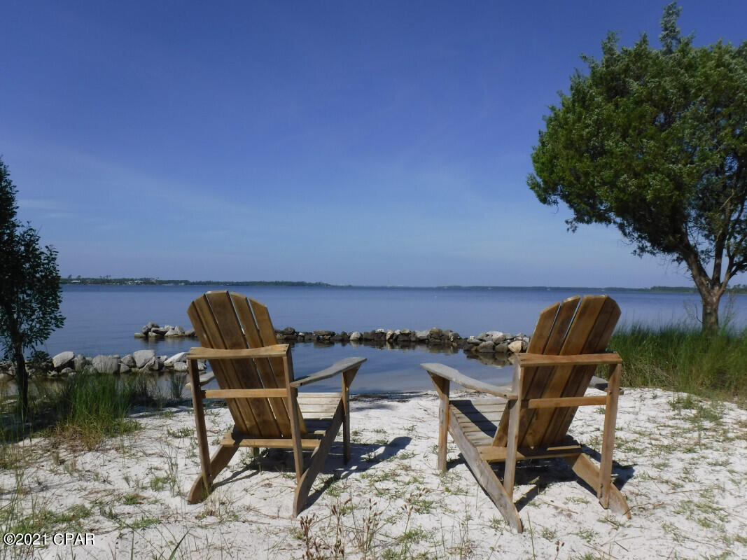 Stunning water views from every room and a gorgeous natural setting make this property one of a kind. This water-front home was built with Florida living in mind. Fishing, sailing, kayaking, swimming, and watching the dolphins are just a few of the choices. You will even have your own private beach! The property is centrally located near Lynn Haven. Features include natural hardwood and marble flooring, stainless steel and Carrara marble counter tops, ample built-ins for office and living areas, operational hurricane shutters plus a large deck for enjoying the outdoors.