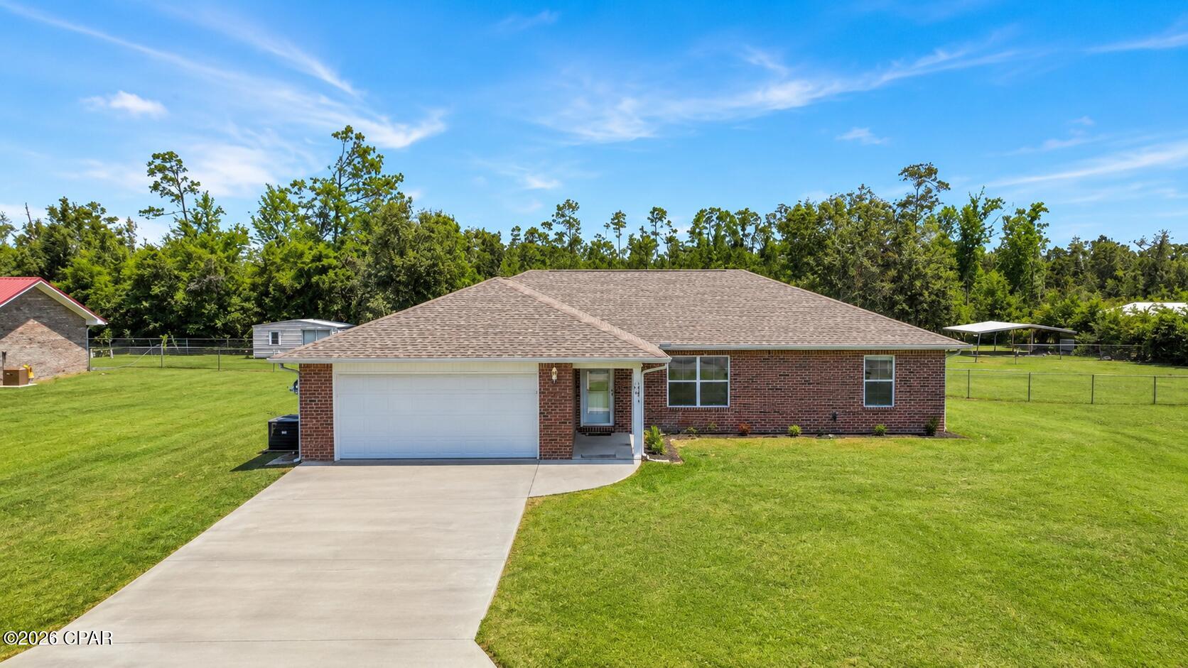 If you've been searching for a property with space, freedom, and versatility, this 3-bedroom, 2-bathroom home checks all the boxes. A huge perk is the brand new roof that was just added in spring 2026. Situated on 1.1 acres in Bay County, this property offers a rare combination of a private pond, a large pole barn complete with its own bathroom, and no HOA restrictions, giving you the flexibility to store your boats, RVs, equipment, or create the workshop you've always wanted.

Inside, you'll find a desirable split-bedroom floor plan designed for privacy and everyday comfort. The spacious living areas provide plenty of room for gathering with family and friends, while the primary suite is tucked away from the guest bedrooms for added privacy.

Enjoy peaceful mornings overlooking the pond, afternoons working on projects in the pole barn, and evenings relaxing on your own piece of Bay County paradise. All of this is conveniently located just 10 minutes from Lynn Haven, offering the perfect balance of country living with easy access to shopping, dining, schools, and everyday conveniences.

Properties offering acreage, a pond, a pole barn, and no HOA are hard to find, don't miss your opportunity to make this one yours.