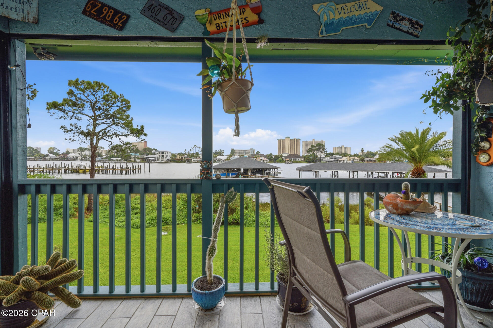 WATERFRONT LIVING ON NORTH LAGOON! Opportunities like this are becoming harder to find. This beautifully updated 3-bedroom, 3-bath condo includes a private covered boat slip, boat lift, jet ski lift, and deep-water access to the Gulf--all included in the purchase price.
Inside, you'll find a bright open-concept floor plan and an oversized south-facing waterfront balcony with plenty of room to relax or entertain while enjoying beautiful water views. Whether you're heading to Shell Island, spending the day fishing in the Gulf, or simply enjoying the waterfront, this property was designed for the boating lifestyle.

Located in Greenwood Estates, you'll appreciate the recent community improvements, including updated docks, common area, pool and more! Just minutes from St. Andrews State Park, marinas, restaurants, shopping, and the beach.
The home has been extensively updated, including a custom white oak staircase with white oak treads, trim, and handrails, satin black iron balusters, and a beautiful pecky cypress accent column. The first-floor guest bath features a new tiled shower floor and new toilet, with new trim in both first-floor bathrooms. Additional improvements include new luxury vinyl plank flooring in the upstairs guest bedroom, fresh interior paint throughout much of the home, a completely rebuilt waterfront balcony with new balusters, new 4x4 posts, and fresh paint, completely rebuilt and stained exterior entry stairs, an updated front porch with new wood, and extensive dock improvements including a new boat lift, new pulleys, jet ski lift, rebuilt dock with new decking, and new shingles on the covered dock.
All appliances and furnishings currently in the home will convey! All you got to do is make it your own!