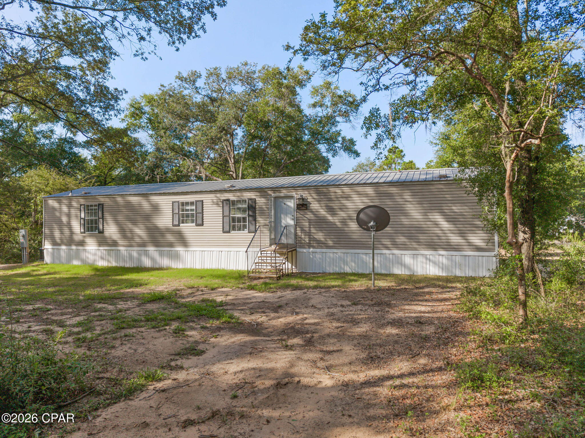 Comfortable, inviting, and surrounded by nature, this 3-bedroom, 2-bath mobile home is ready for its next owner. Inside, you'll find an open-concept layout that connects the living room and kitchen, creating a welcoming space for everyday living. The kitchen offers plenty of cabinet and countertop space, while the split-bedroom floor plan provides separation between the primary suite and the additional bedrooms. The primary bedroom includes its own private bath, and the two guest bedrooms share a full bath. Step outside and enjoy the spacious yard, shaded by mature trees and offering plenty of room for outdoor activities, pets, or simply relaxing in a quiet country setting. Whether you're a first-time homebuyer, looking to downsize, or searching for an investment property, this home is ready for its next owner. Call today to schedule your private showing!