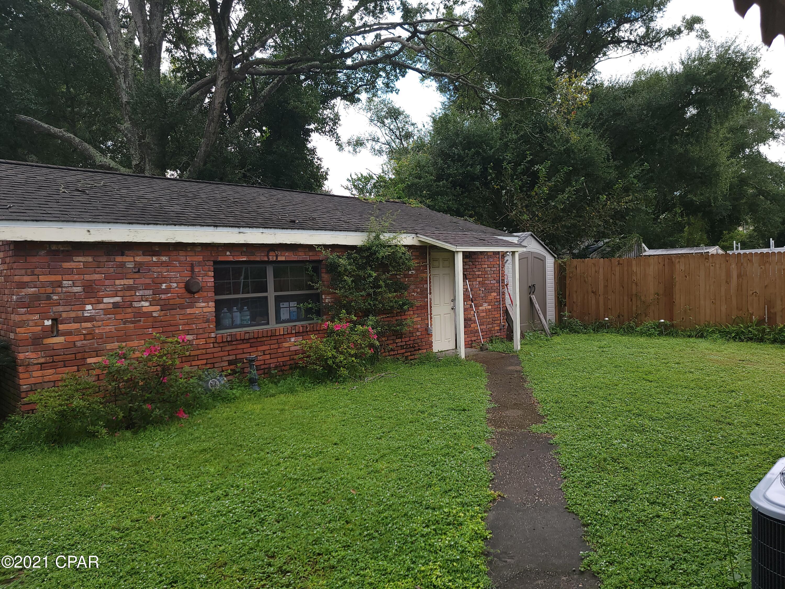 An old Family Home that was build in 1944 by the father of the current seller.  A brick home with enclosed yard and surrounded with a 6 ft. wood fence.  The roof was installed in 2019 base on the listed permit.  There is a parking location for your motor home with electric and sewer hook up.  There is a shop to work on your antique cars seperate from the house. The major appliances in the kitchen and the air conditioner is less than two years old.   This is a three bedroom house with 2 bath older home.  Large kitchen and play room with a fireplace.

This property is currently zoned mixed use. Lucile Moore school is across the street.  All measurements are approximate.