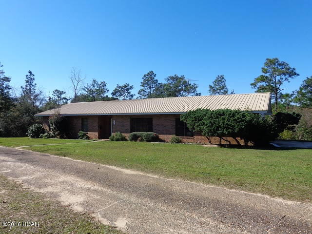WATERFRONT ON BLUE LAKE. This is an all natural 5 acre spring fed pond. Great fishing and enjoy swimming. 145 ft frontage on pond. New boat dock totally rebuilt with pressure treated wood in 2012. Only the property owners around pond have access. End of dock water is 14 ft deep, pond is believed to be 35ft deep. Great view of pond from the back sun porch. 3/2 all brick ranch that was built to original owners specs. Metal roof new in 2003. Spacious living room, kitchen & dining room combo which all the newer energy saver appliances will convey even the front load washing machine. Laundry room with plenty of cabinets and counter tops for storage plus an open pantry. 2 compact car garage that has additional storage room that houses the water softner, attic access plus garage has it's own H/AC ceiling fans, auto garage opener & inside water spigot. Master bath with new laminate tile flooring & new paint. 16x20 workshop with 2 car carport. Insulated workshop has built in work bench & shelving, AC window unit new in 2015, wired for DSL, mop sink, wood floor, high ceilings, flood lights, water & electric. Garden area, fruit trees, flowering bushes, walking paths & newly fenced back yard for pets. 100 yard shooting range with 3 berms, one at 25, 50 & 100 yards. Most of White Drive is paved to house. Close drive to Hwy 231.
