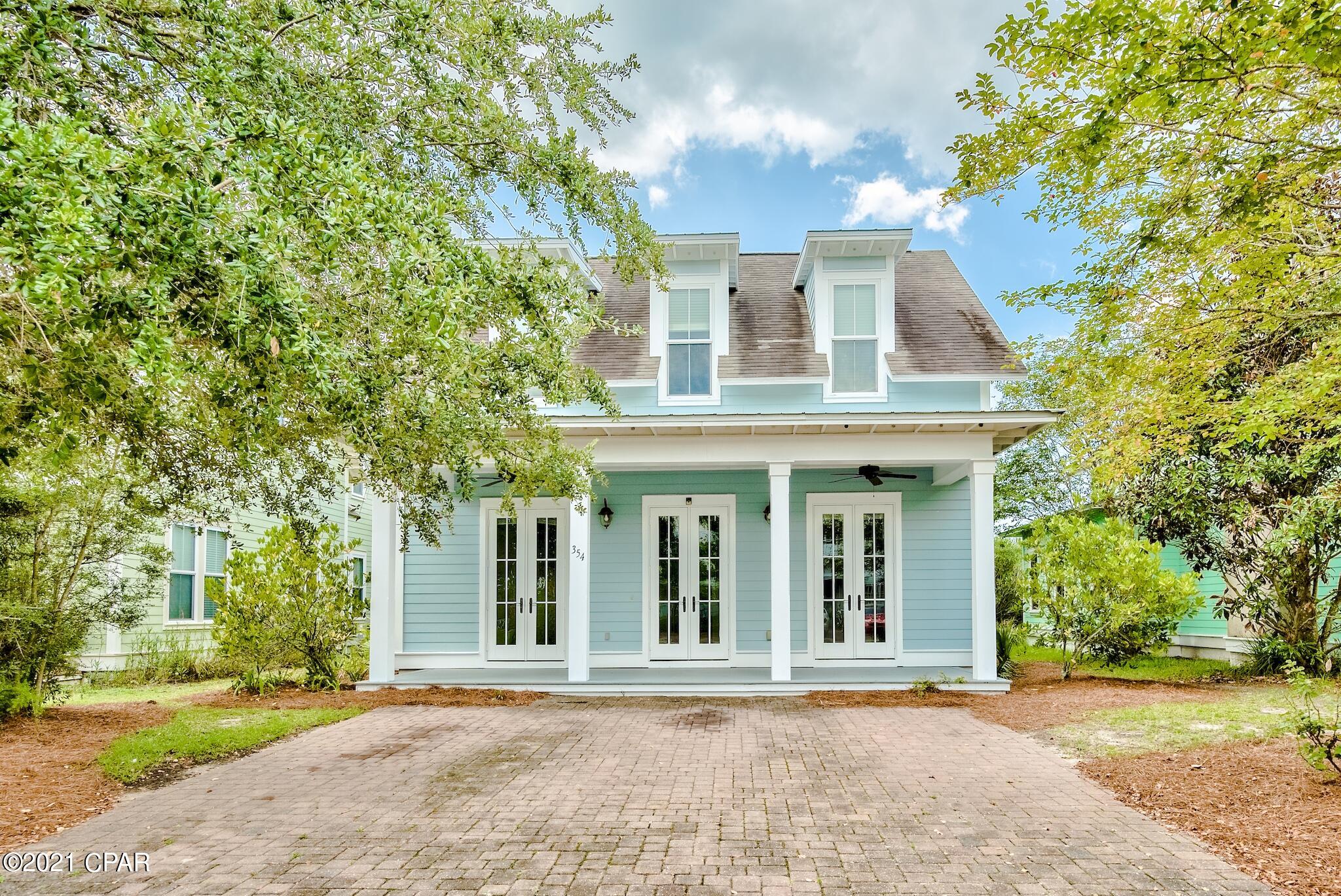 Beautiful 4-bedroom, 3.5-bath home in Harrison's Walk, a great community close to the beach. Incredible price for a home this spacious and close to the Gulf of Mexico! This home has great curb appeal with a covered front porch and brick paver driveway. Interior offers beautiful tile floors throughout the common areas, raised ceilings, and great natural light. Craftsmanship details like crown molding and white wainscoting give the property a beach cottage feel. This is a fantastic open floor plan with a ground floor master bedroom for added convenience and three guest bedrooms on the upper level. Great kitchen with wood cabinets, expansive granite countertops, and a breakfast bar with pendant lighting. All bathrooms feature granite as well. There is plenty of seating with a formal dining area off the kitchen as well as a breakfast bar and open dining area. The master bedroom is conveniently located downstairs and is very spacious with an en-suite bathroom. The master bath features a double vanity, granite countertops, and a shower/tub combo. There are three guest bedrooms upstairs, one with an en-suite bathroom and the other with a shared bath. There is also a great flex space at the top of the stairs with hardwood floors that could ideally be another living area, lounge or office. If you are looking for a home close to the beach with nice privacy, this is it! The community does not allow short term rentals, making this home the perfect primary residence or long term rental (6 months+ required). Harrison's Walk offers a nice community pool and is close to many great attractions & conveniences.