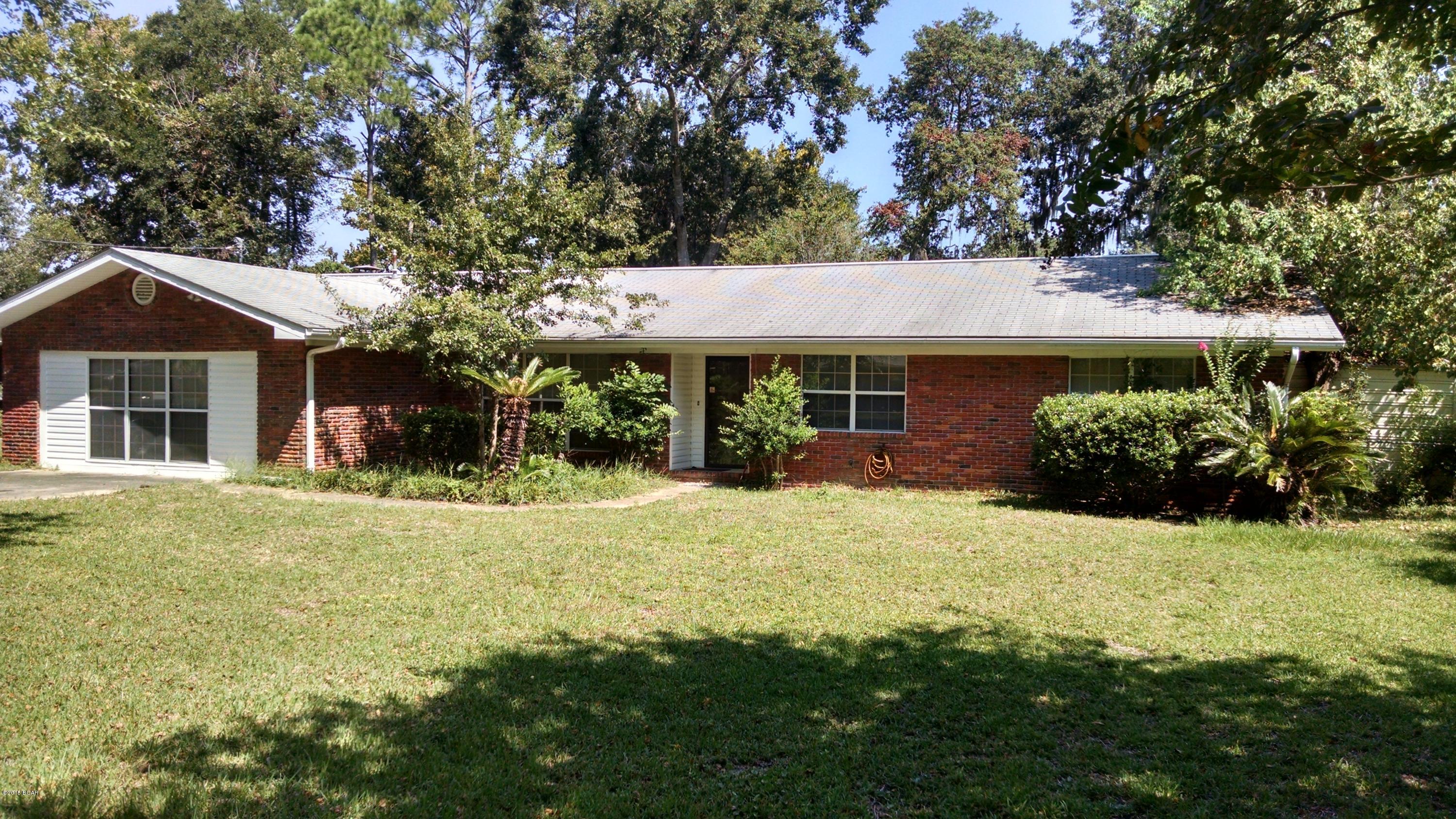 Solid brick, 4 bedroom, 2 bath home in desirable neighborhood close to Tyndall AFB, shopping and schools.  With some sweat equity, the value in this home can only go UP UP UP!!! The interior features a sunk in living area, formal dining room, family room with brick fireplace and a kitchen with solid wood cabinets.  All of the bedrooms are very large with abundant storage.  A screened in porch overlooks the fenced in back yard with a sunk in pool.  Come see this one today!!!!