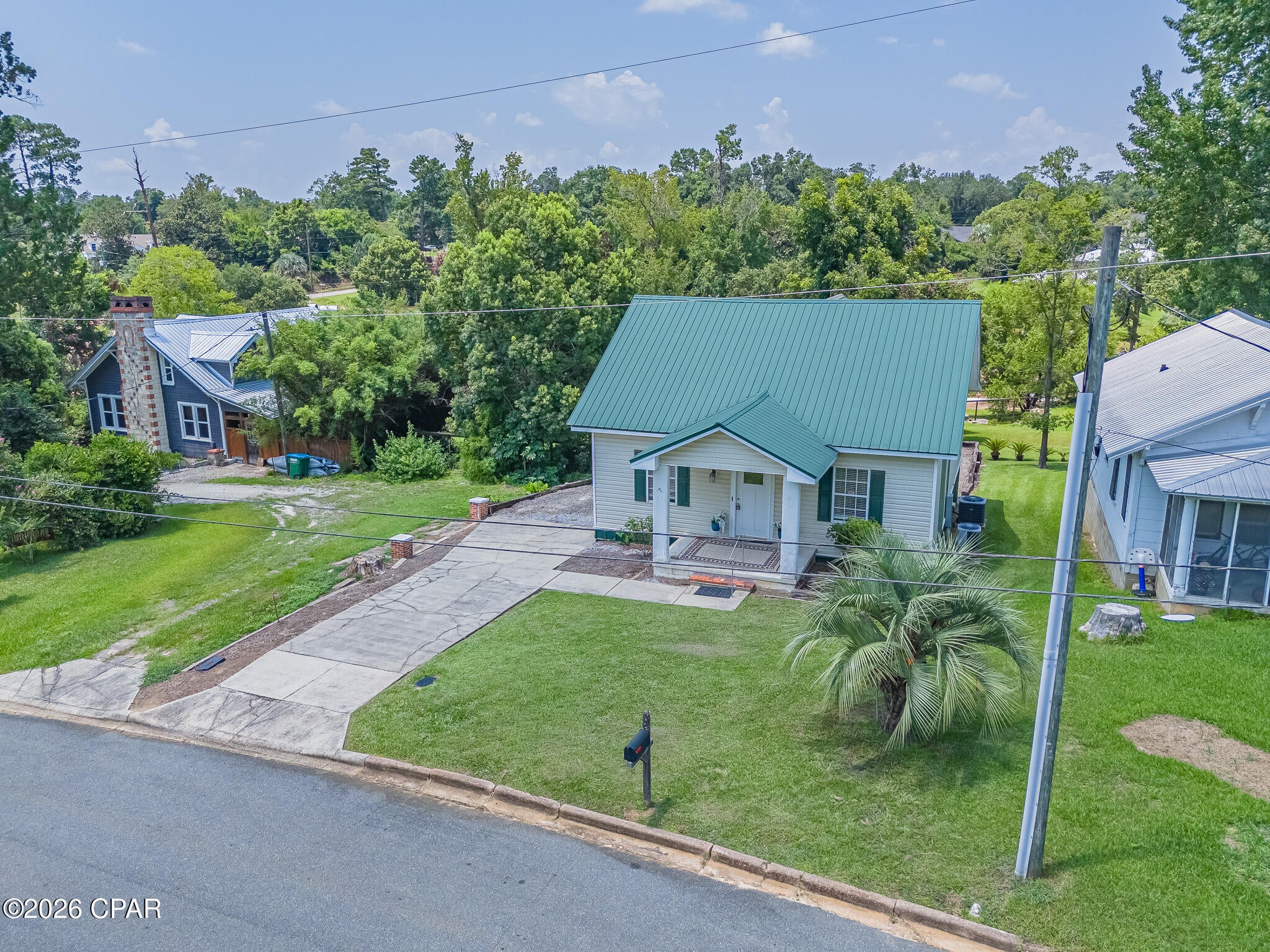 Welcome to 4396 Florence Drive in the heart of Marianna! This beautifully maintained 3-bedroom, 2.5-bath home offers 1,692 square feet of comfortable living space with timeless character and thoughtful updates. Overlooking Wynn Street Park, the home features a spacious open-concept living and dining area highlighted by stunning high-gloss tongue-and-groove wood ceilings that create a warm, inviting atmosphere. The galley-style kitchen comes equipped with a refrigerator, stove, dishwasher, and offers a cozy breakfast nook with peaceful park views. The first-floor primary suite includes a private bath and walk-in closet, while two additional upstairs bedrooms and a full bath provide plenty of space for family or guests. Outside, you'll find a low-maintenance yard, a large rear deck with additional storage underneath, an oversized crawlspace for even more storage, and a rock driveway with parking for up to six vehicles. Conveniently located near shopping, medical facilities, schools, and downtown amenities, this move-in-ready home offers comfort, convenience, and exceptional value. Don't miss your opportunity to own this charming Marianna home--schedule your private showing today!