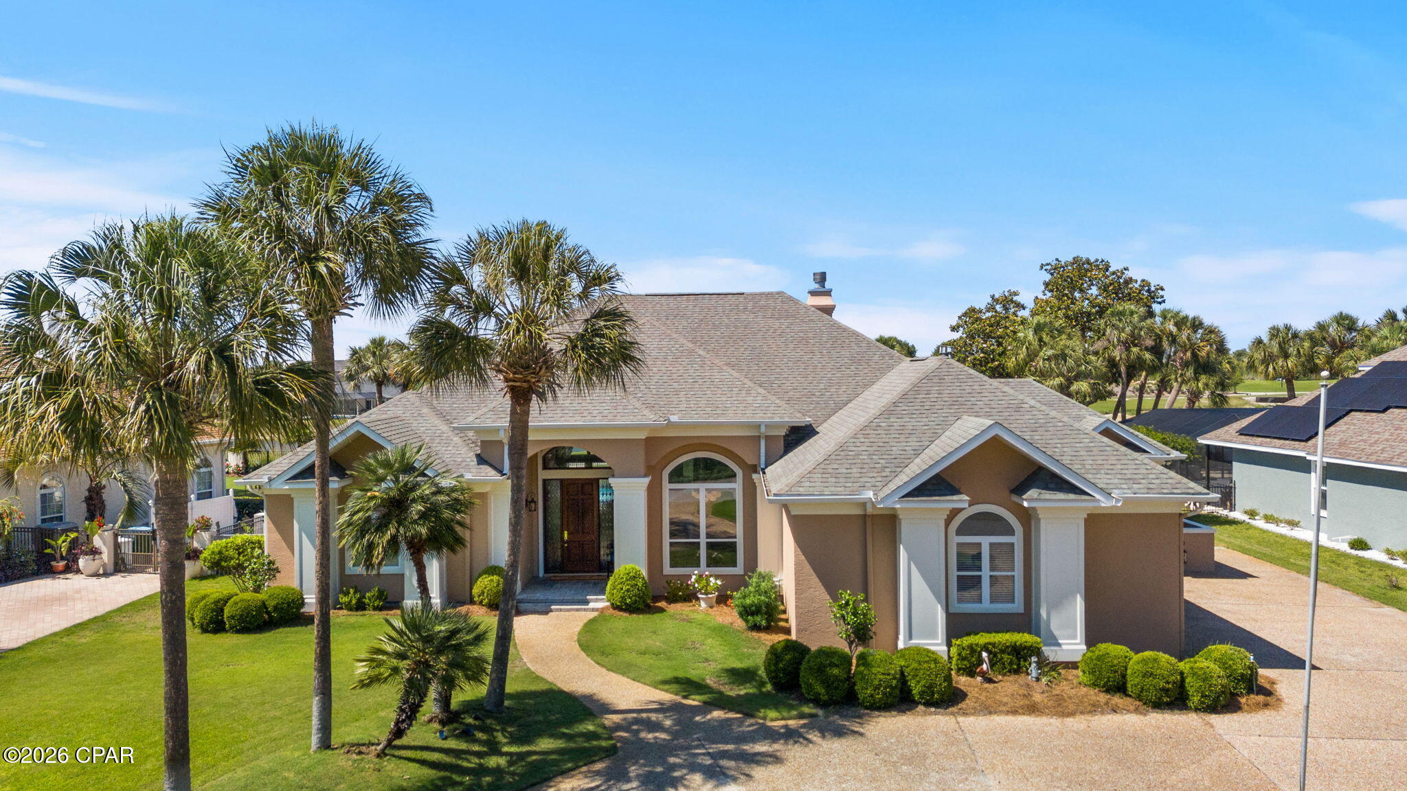Upgrade your Zoom background permanently.  Work from a private home office overlooking the green, take your lunch break by your private pool, and live minutes from the Gulf beaches.  Nestled within the prestigious Queensberry neighborhood of Bay Point, this pristine 3,055-square-foot estate offers a masterclass in upscale coastal living. From the moment you pull into the expansive circular driveway, the home's grandeur is evident, highlighted by soaring 14-foot ceilings and high-end crown molding that flow through multiple light-filled living spaces. Recent premium upgrades ensure modern comfort and peace of mind, including a newly renovated primary bathroom (2025), fresh interior paint, and a suite of high-end appliances replaced between 2022 and 2024. Practical luxury is woven into every detail, from the built-in bookcases and gas fireplace to the expansive laundry suite that effortlessly transitions into a home gym or craft room.

The heart of the home is a chef's dream, featuring a farmhouse sink, gas stove, and custom cabinetry equipped with pull-out organizers. Designed for both functionality and charm, the residence boasts smart conveniences like power window shades, a central vacuum system, and floor-integrated outlets for seamless furniture placement. Seasonal decorating is made effortless by a specialized front-porch timer for holiday lighting, while the exterior is fully fortified with hurricane fabric and shutters. With a three-car garage providing ample storage and one of the two HVAC units replaced in 2022, every mechanical and aesthetic detail has been meticulously maintained.

Wake up to pristine fairway views, spend your morning on the only Nicklaus Design course in Northwest Florida, and your afternoon at St. Andrews State Park.  This isn't a vacation, it's your everyday life.  The outdoor experience is truly your own slice of paradise, situated perfectly between the 10th hole and 11th tee box of the Legends golf course. The backyard sanctuary features a heated in-ground pool with a tranquil waterfall--newly resurfaced in 2024--surrounded by professional landscaping and breathtaking views. Whether you're watching a family of deer graze on the green at dawn or enjoying the glow of the 2023 exterior lighting at dusk, the atmosphere is one of total serenity. Tucked away from the city's hustle yet just minutes from the white sandy beaches and local amenities, this home offers the rare balance of an established, quiet community with world-class leisure right at your doorstep.